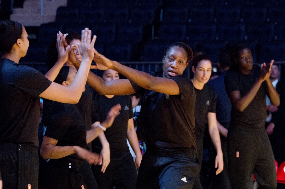 Members of the New York Liberty basketball team enter the court for a game against the Atlanta Dream, Wednesday, July 13, 2016 in New York. Between the Black Lives Matter movement, the Orlando shooting and the LGBT community, more WNBA players have been taking active roles in expressing their views on social issues. In the midst of “Camp Day” at the New York Liberty’s mid-morning game Wednesday, Liberty players stood in solidarity as they donned all-black warmups in support of the Black Lives Matter movement. (AP Photo/Mark Lennihan)