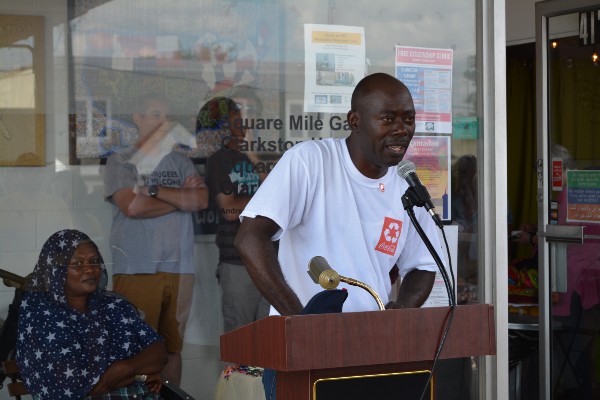 Libertian refugee Monica Sherriff, and Congolese refugee and Leon Shombana speak at the World Refugee Day celebration. CREDIT: Kira Lerner
