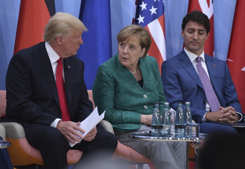 US President Donald Trump, German Chancellor Angela Merkel and Canada’s Prime Minister Justin Trudeau, from left, at the G20 summit in Hamburg, Germany. CREDIT: Patrik Stollarz/Pool Photo via AP