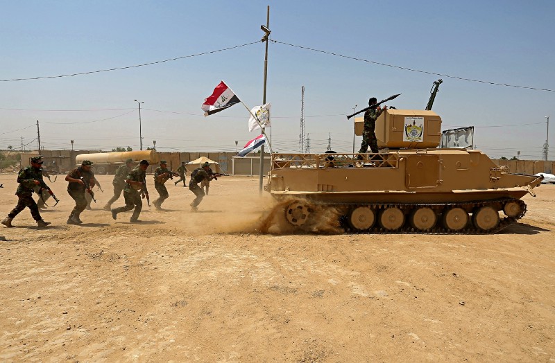 Shia Volunteers fighters of the Imam Ali Brigade, an armed faction with the Iraqi Popular Mobilization Forces (aka Hashd al-Shaabi), train in their camp in Najaf, 100 miles south of Baghdad. CREDIT: AP Photo/Anmar Khalil