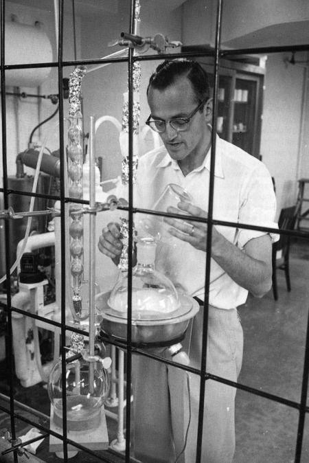 A young Clair Patterson conducts research on trace amounts of lead at Caltech in 1957. CREDIT: Caltech E&S Magazine, 1997
