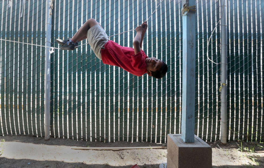 High levels of soil lead in this northwest Santa Ana home exposed the children raised here to lead, including a newborn, a 2-year-old girl, and the 9-year-old boy seen here playing in his backyard. Lead exposure is the most dangerous for the developing brains of young children. CREDIT: Daniel A. Anderson for ThinkProgress