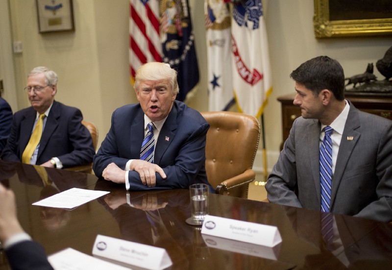President Donald Trump, flanked by Republican congressional leaders Paul Ryan and Mitch McConnell in June. CREDIT: AP Photo/Pablo Martinez Monsivais