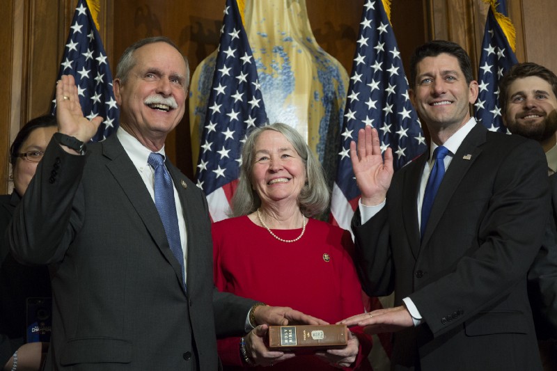 Rep. David McKinley (R-WV), left, sponsored an amendment that restored fossil fuel research funding to its 2017 level of $668 million. CREDIT: AP Photo/Zach Gibson