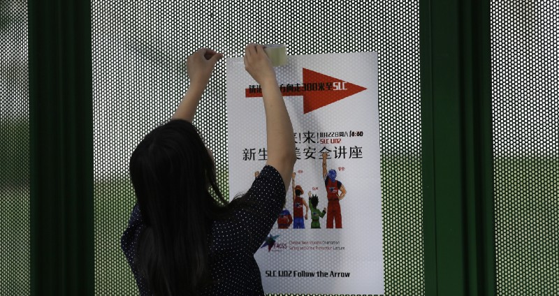 In this photo made Saturday, Aug. 22, 2015, Ailu Xu, a graduate student from China, posts a sign directing Chinese students to a new student orientation meeting at the University of Texas at Dallas in Richardson, Texas. The U.S. Census Bureau research shows immigrants from China and India, many with student or work visas, have overtaken Mexicans as the largest groups coming into the U.S. CREDIT: AP Photo/LM Otero