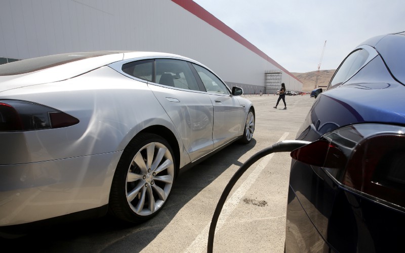 Tesla Motors cars are charged at the new Tesla Gigafactory in Sparks, Nevada, a $5 billion factory in the Nevada desert aiming to dramatically boost the world’s production of lithium-ion batteries. CREDIT: AP Photo/Rich Pedroncelli