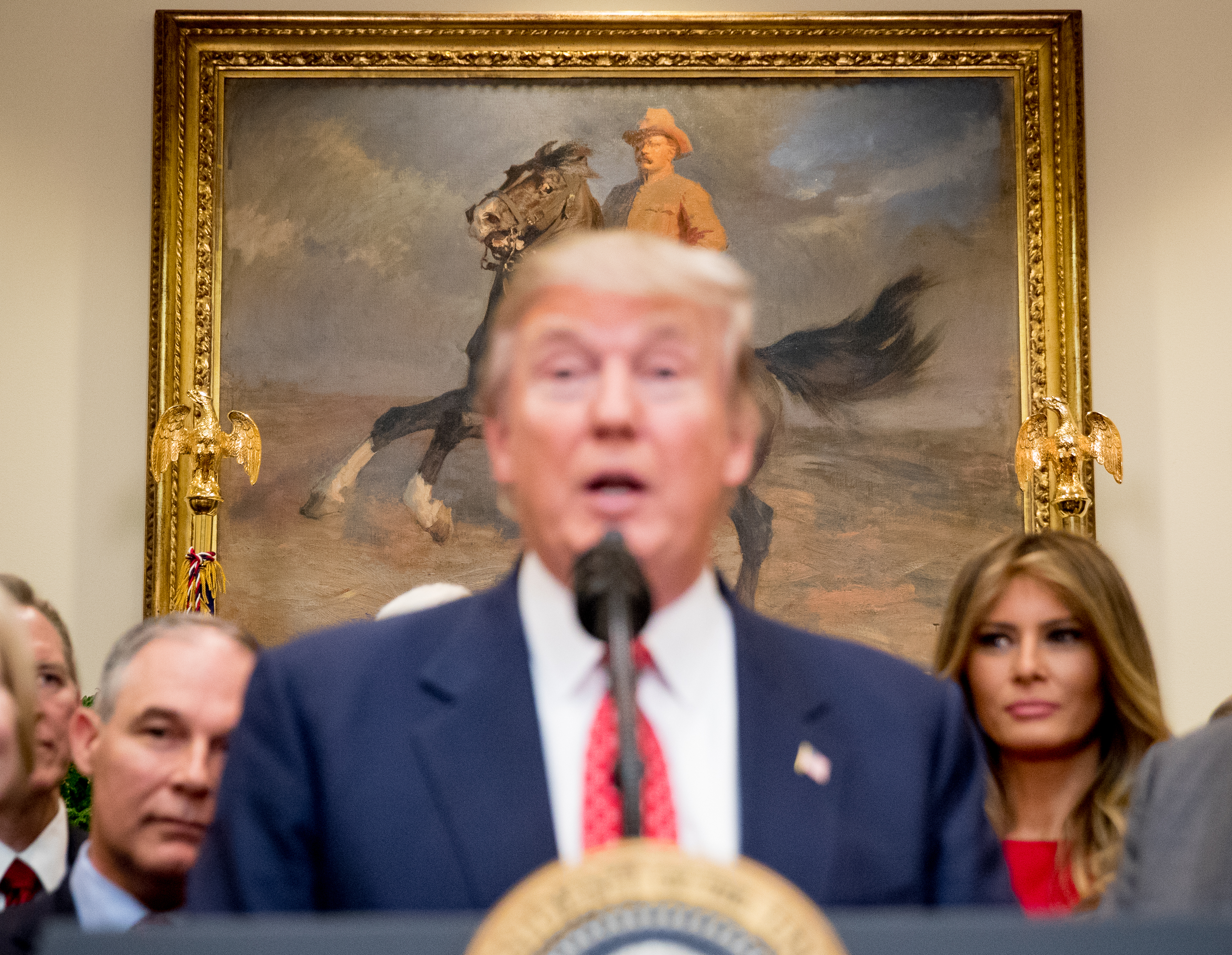 Under a painting of former President Teddy Roosevelt, President Donald Trump speaks before signing another anti-environmental executive order. February 28, 2017. Credit: AP/Andrew Harnik