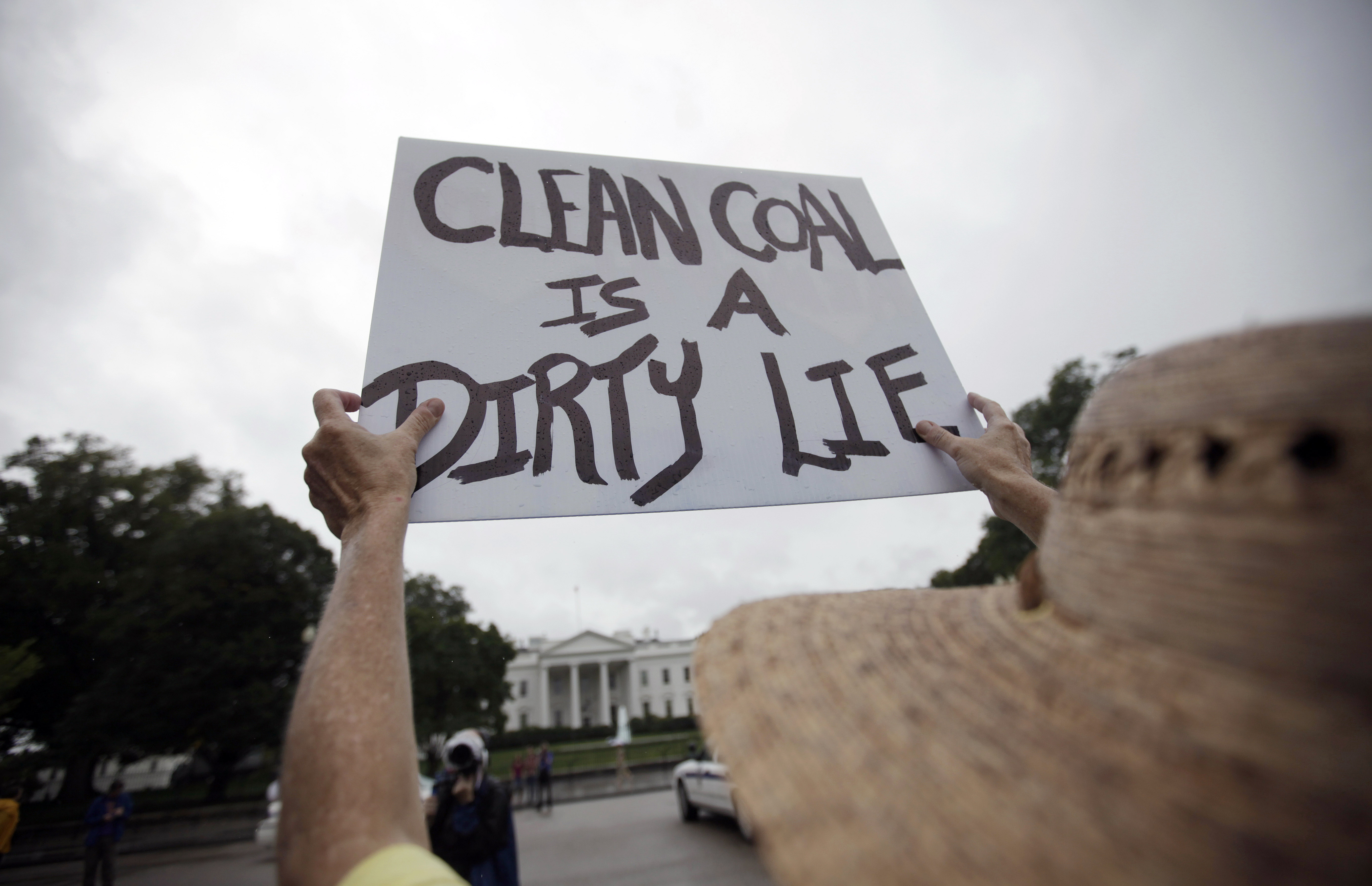 A sign is held high in front of the White House in September 2010, during a demonstration to protest against the coal industry and call for the end of mountaintop removal for mining. CREDIT: AP Photo/Carolyn Kaster