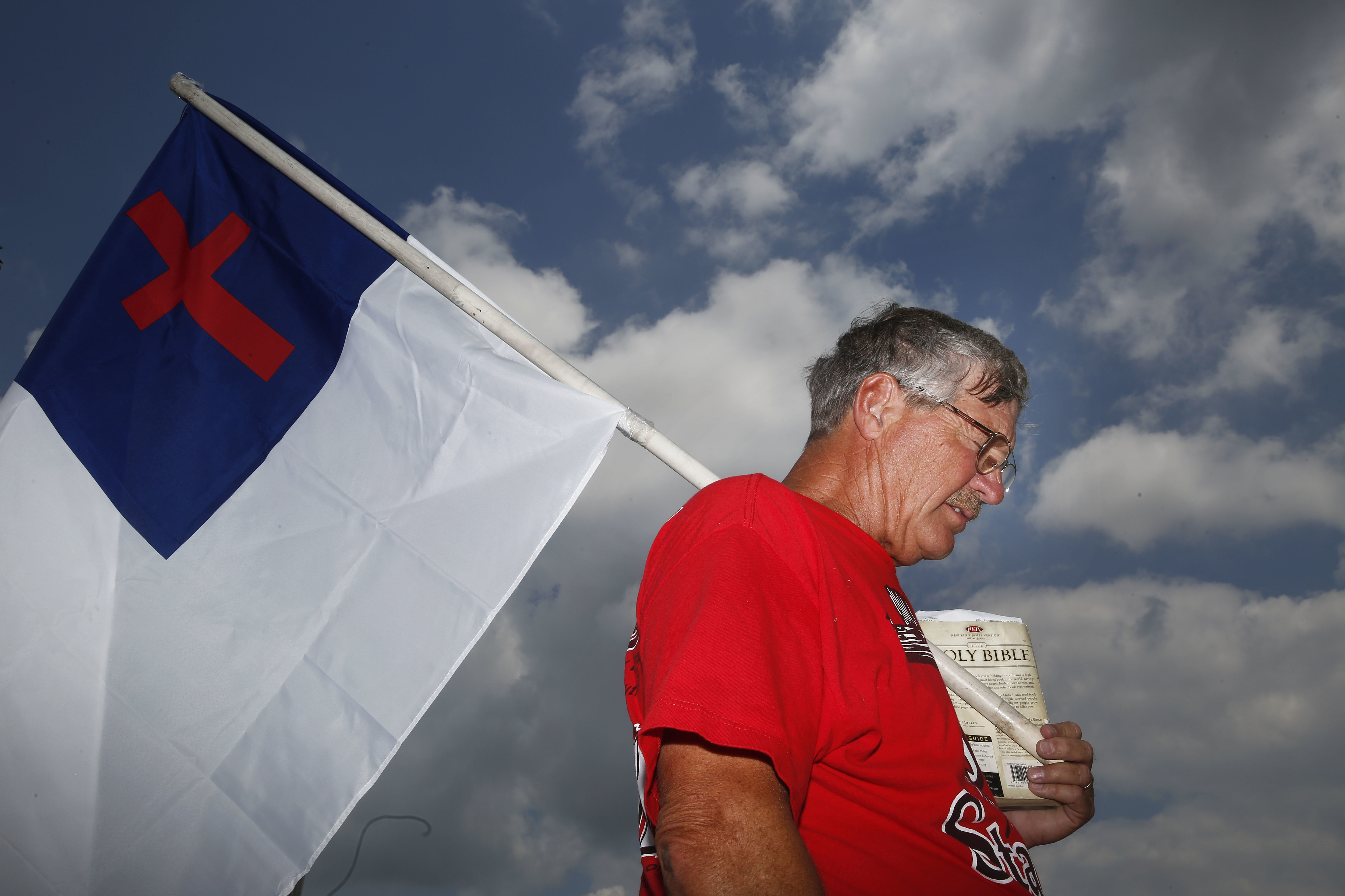 Ken Scott, a supporter of then-suspended Chief Justice Roy Moore, prays during a rally in Montgomery, Alabama on Monday, Aug. 8, 2016. CREDIT: AP/Brynn Anderson