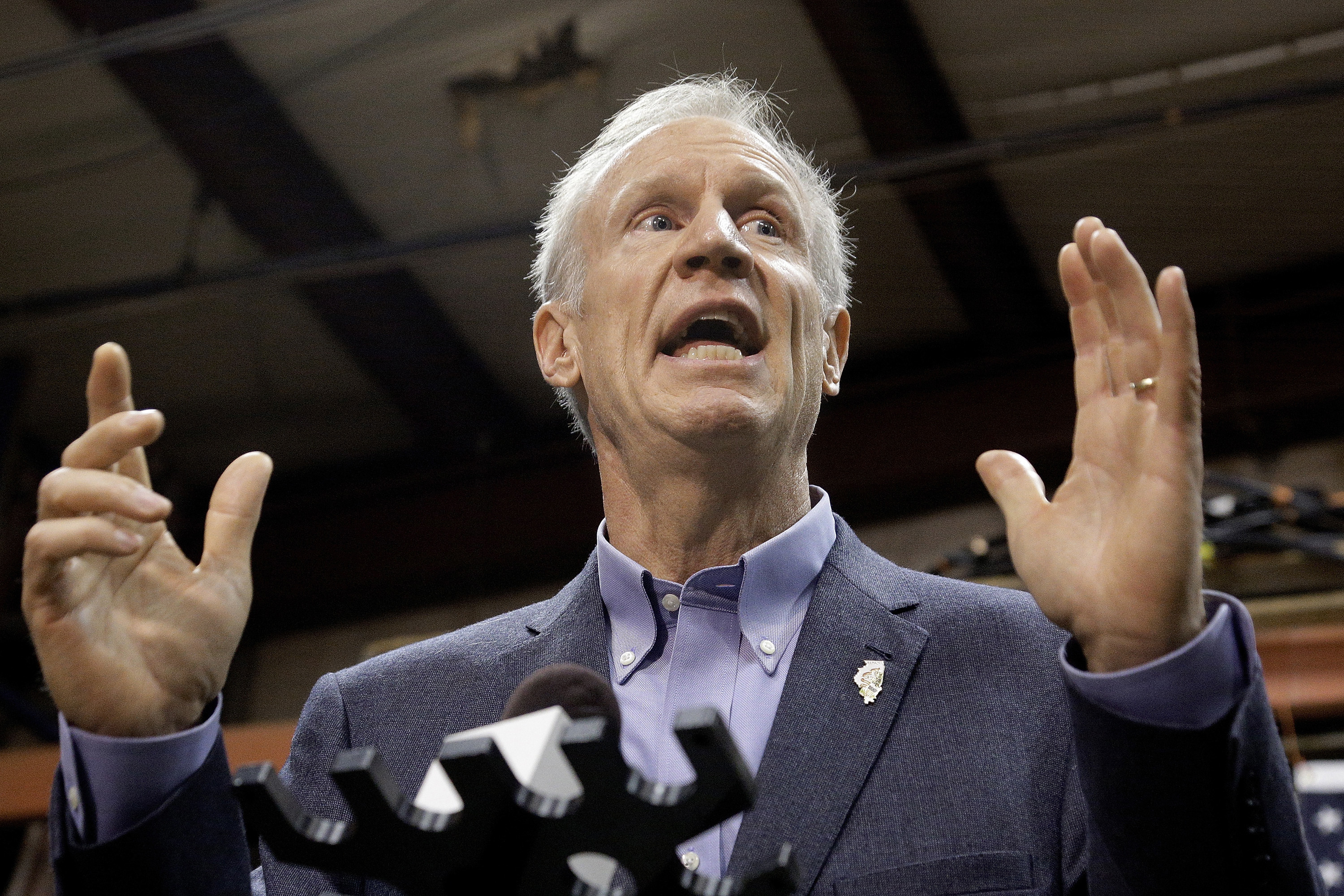 FILE - In this Nov. 16, 2016 file photo, Illinois Gov. Bruce Rauner speaks to reporters in Springfield, Ill. Gov. Rauner has eliminated a backlog of more than 2,000 clemency requests he inherited from previous administrations. The Republican said Monday, Dec. 12, 2016, acting on the requests is part of his effort to improve Illinois' criminal justice system and help people convicted of crimes go on to lead productive lives. (AP Photo/Seth Perlman File)