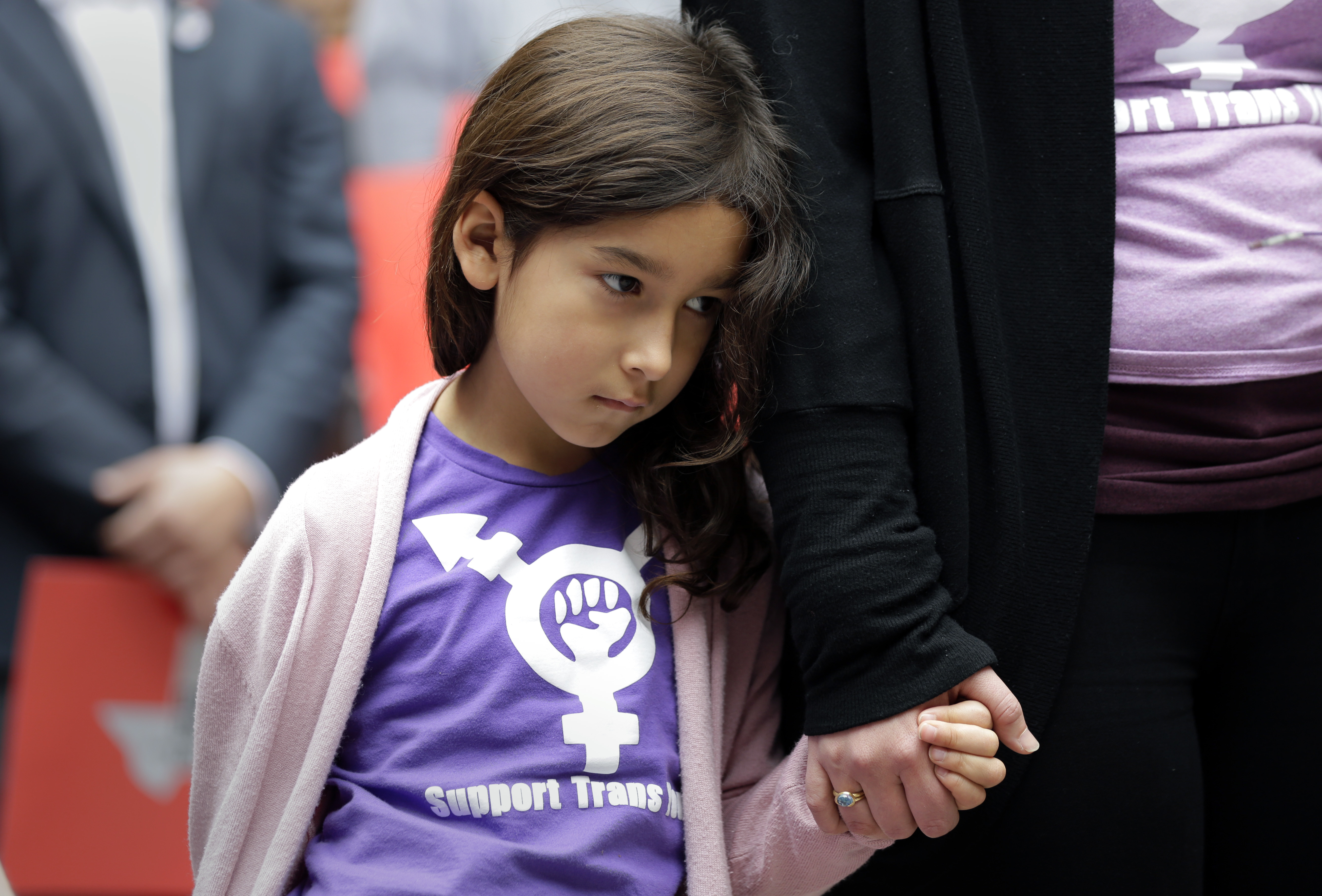 Libby Gonzales, a transgender girl, stands with her mother, Rachel, as members of the transgender community and others who oppose Senate Bill 6 protest in the exterior rotunda at the Texas Capitol as the Senate State Affairs Committee holds hearings on the bill, Tuesday, March 7, 2017, in Austin, Texas. The transgender "bathroom bill" would require people to use public bathrooms and restrooms that correspond with the sex on their birth certificate. (AP Photo/Eric Gay)