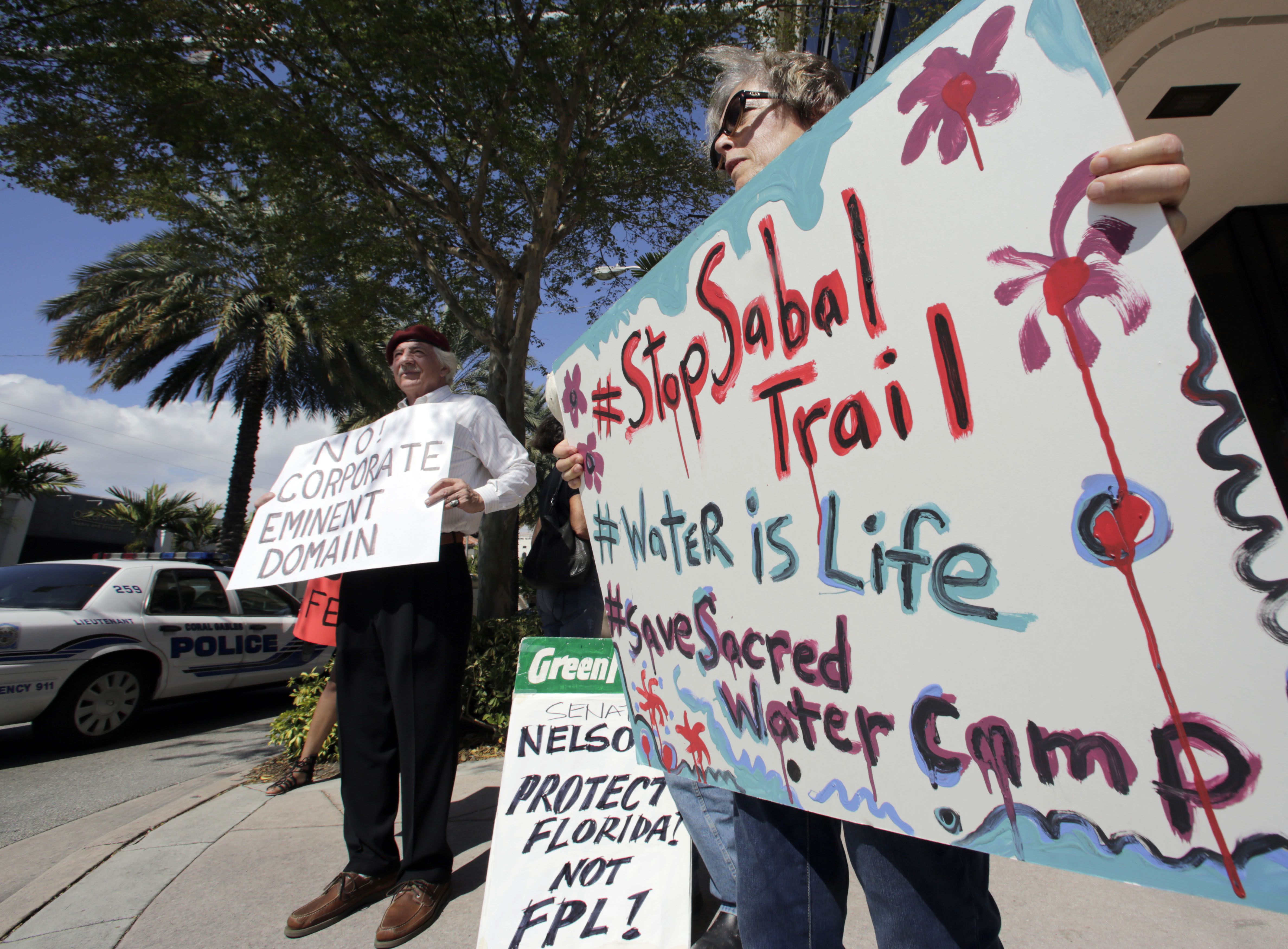 Sabal Trail pipeline protesters hold signs in front of the office of U.S. Sen. Bill Nelson in Coral Gables, Florida in February. CREDIT: AP Photo/Alan Diaz