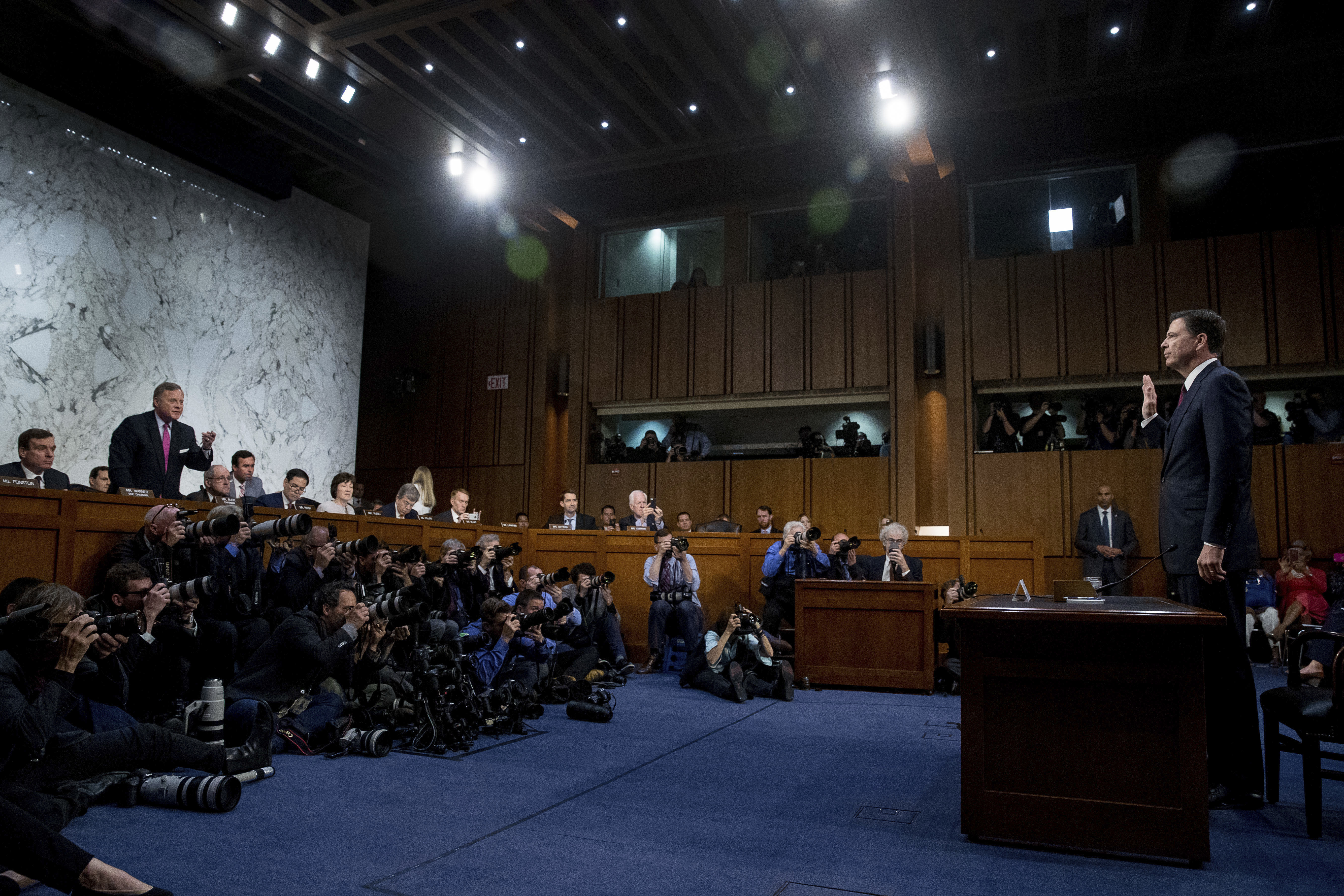 Former FBI director James Comey is sworn in during a Senate Intelligence Committee hearing on Capitol Hill, Thursday, June 8, 2017, in Washington by Senate Intelligence Committee Chairman Richard Burr, R-N.C., standing left. (Credit: AP Photo/Andrew Harnik)