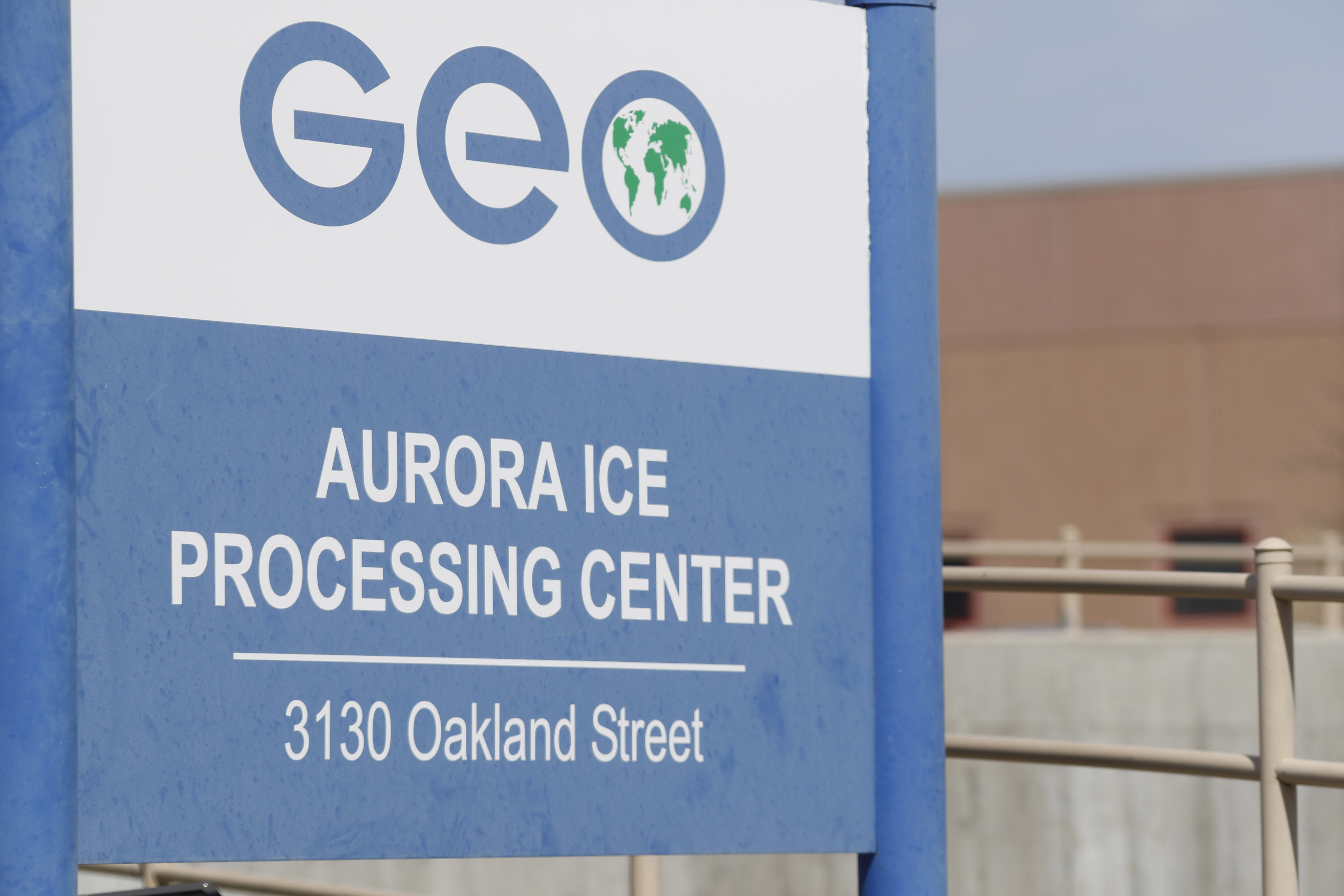 This Saturday, April 15, 2017, photograph shows the entrance to the GEO Group's immigrant detention facility in Aurora, Colo. People once held in a privately run Colorado immigration detention center are challenging the system used to keep it clean and maintained, arguing it borders on slavery. They have won the right to sue GEO Group on behalf of an estimated 60,000 people held at its detention center near Denver over a decade. (AP Photo/David Zalubowski)