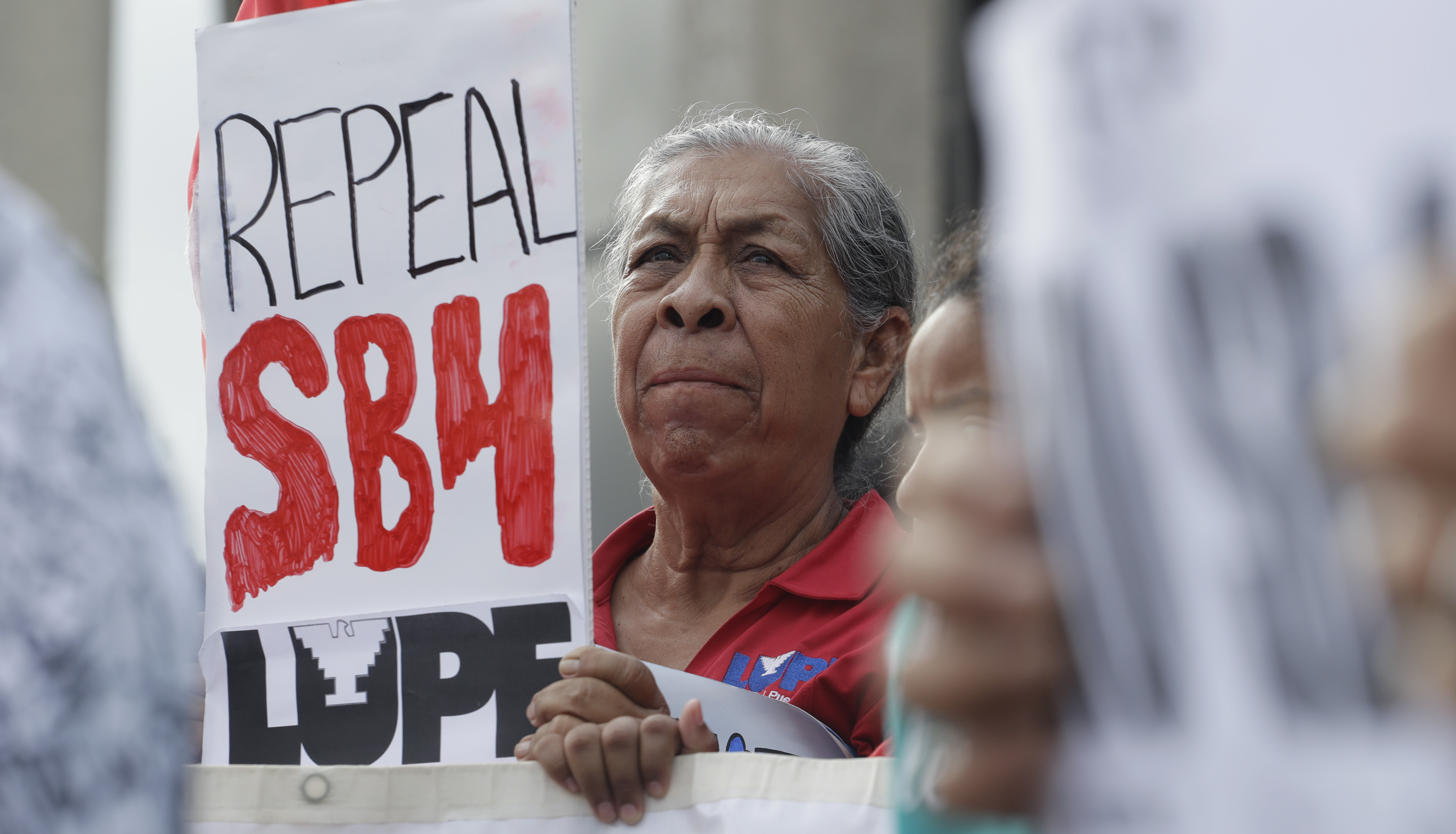 Protesters gather outside the Federal Courthouse to oppose a new Texas "sanctuary cities" bill that aligns with the president's tougher stance on illegal immigration, Monday, June 26, 2017, in San Antonio. CREDIT: AP Photo/Eric Gay
