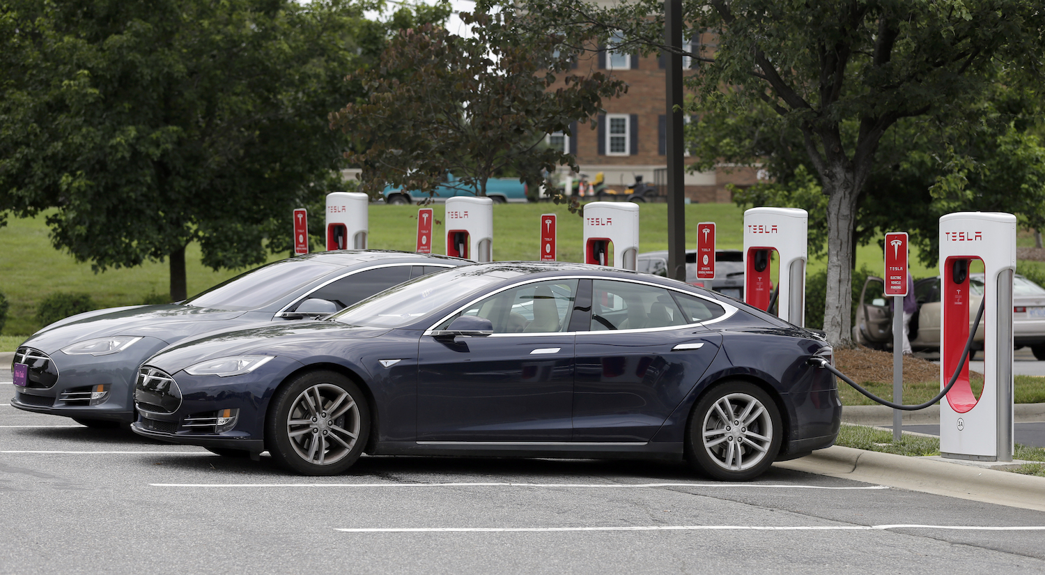 Recharging Telsa cars. CREDIT: AP/Chuck Burton