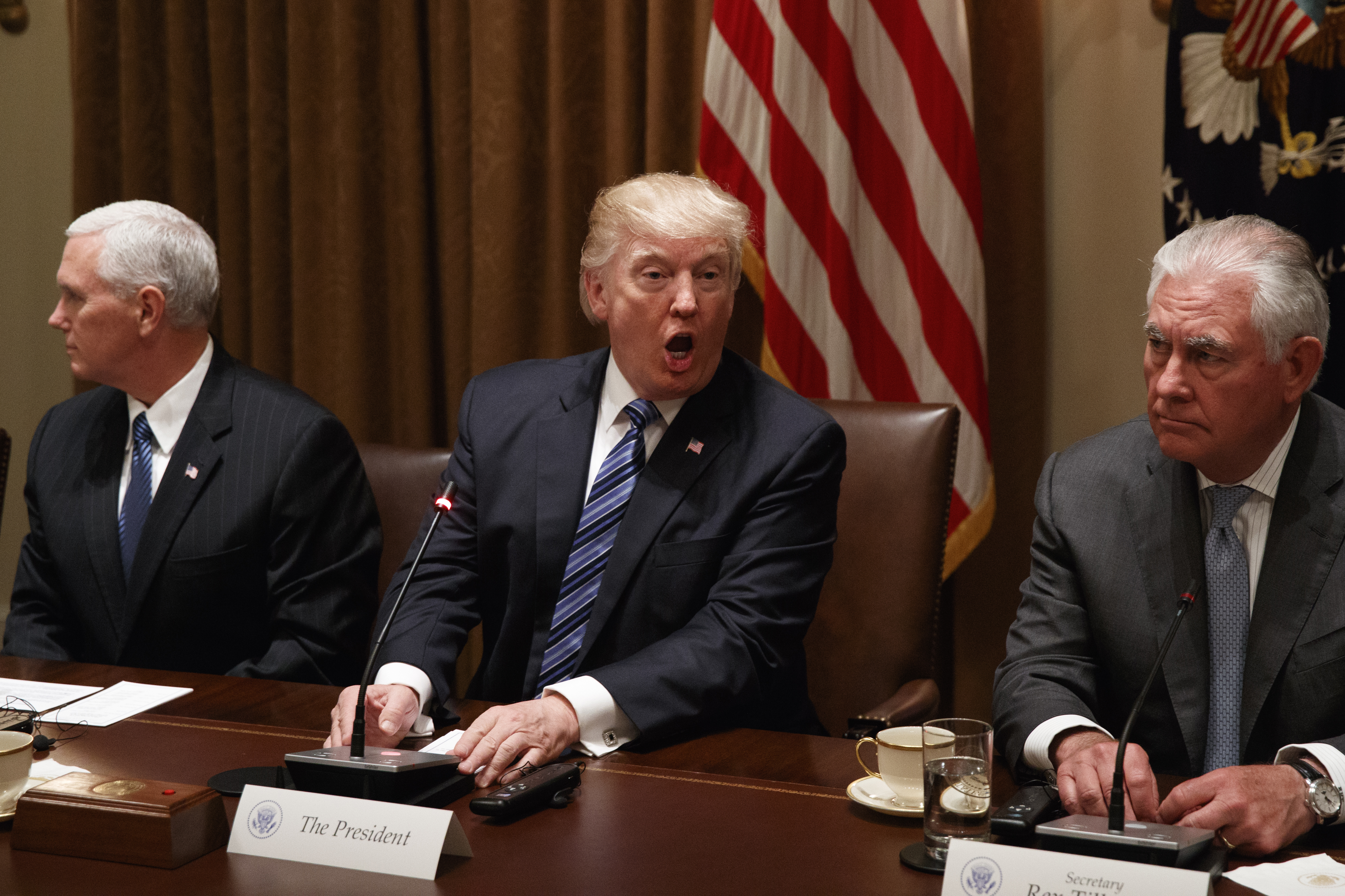 President Donald Trump, flanked by Vice President Mike Pence and Secretary of State Rex Tillerson. CREDIT: AP Photo/Evan Vucci