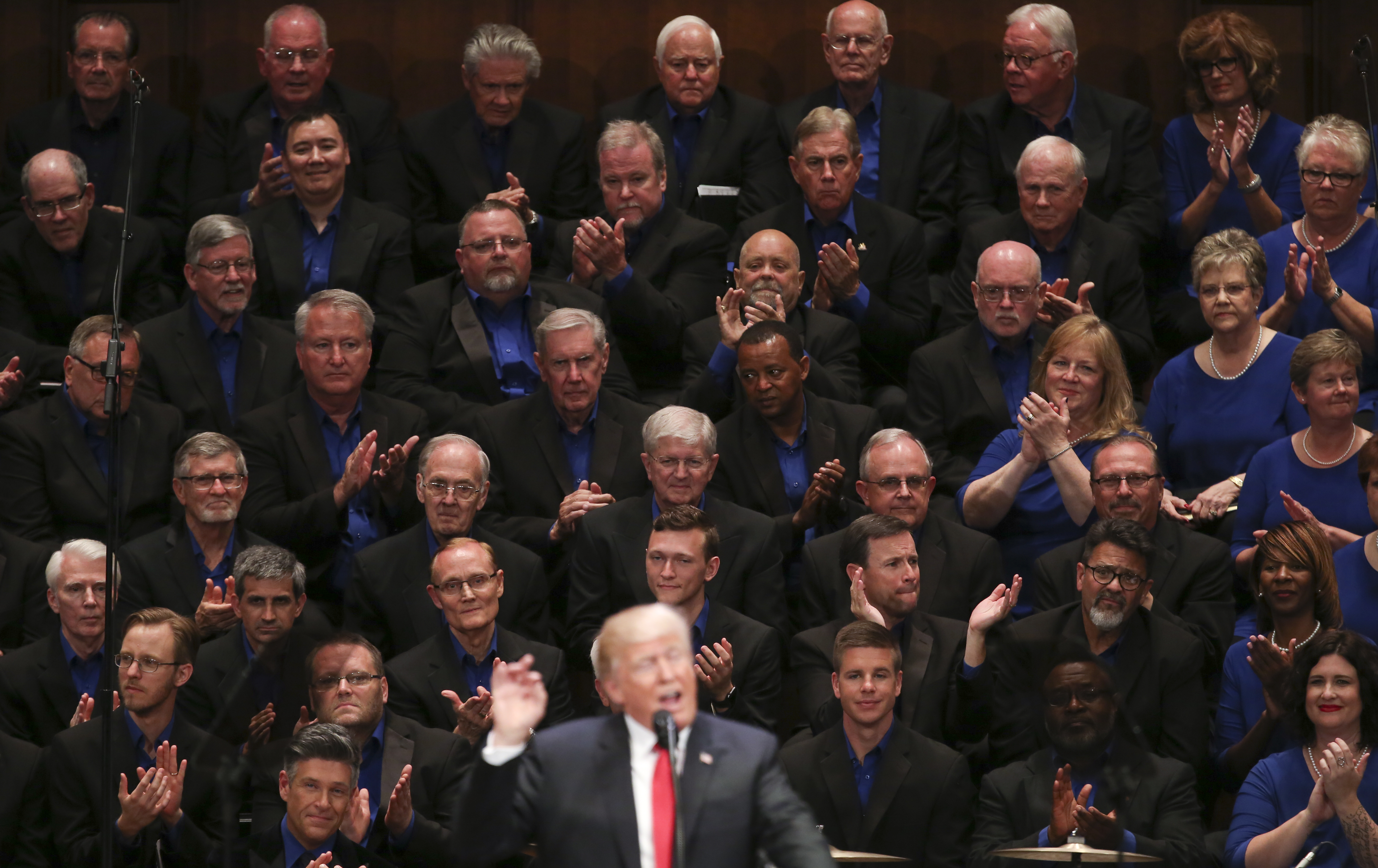 Members of the First Baptist Dallas Church Choir are seated behind President Donald Trump as he speaks during the Celebrate Freedom event. CREDIT: AP/Carolyn Kaster