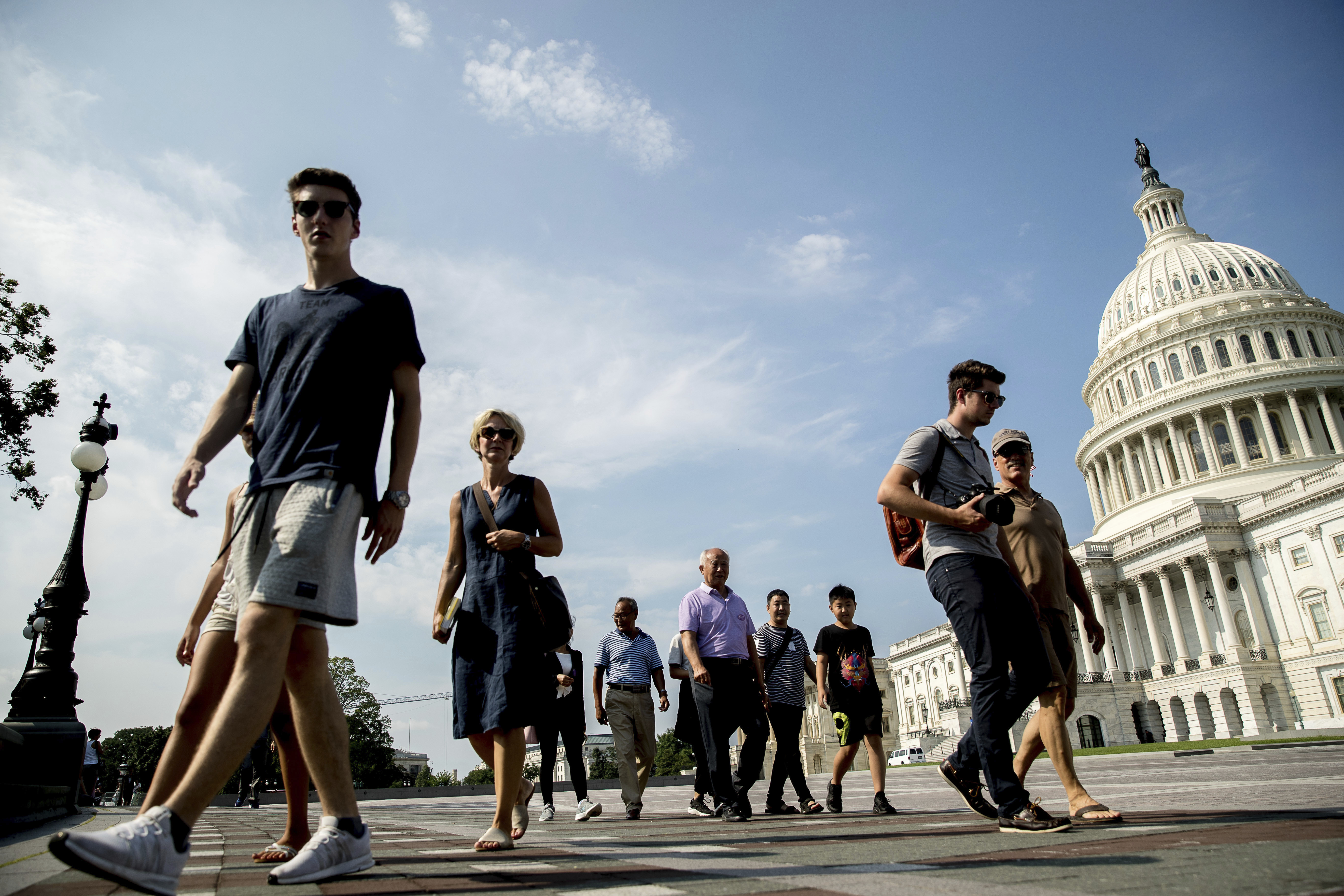 Tourists walks past the Capitol Building in Washington, Monday, July 17, 2017. CREDIT: AP Photo/Andrew Harnik