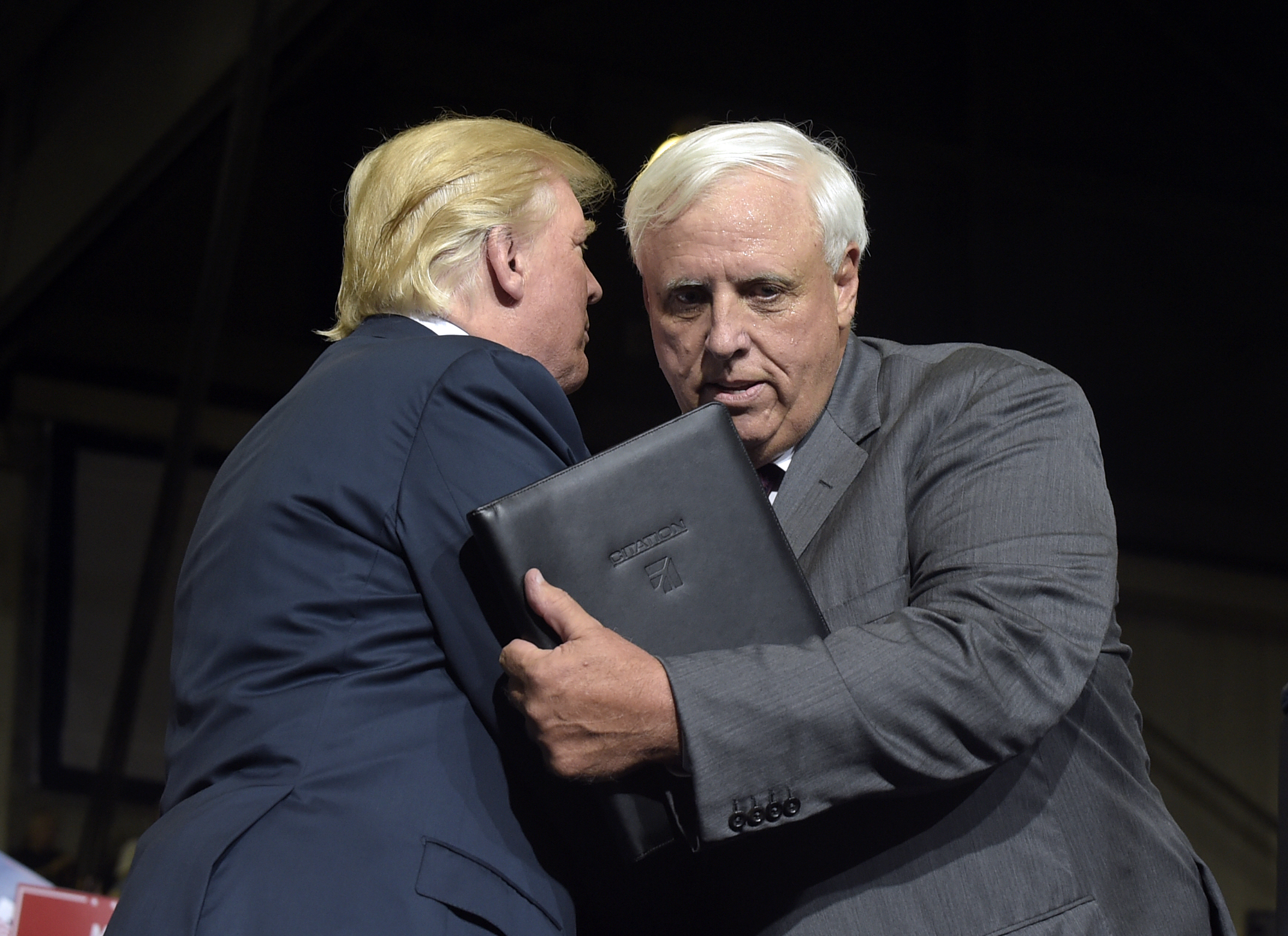 President Donald Trump, left, hugs West Virginia Gov. Jim Justice, right, after Justice announced at a campaign-style rally at Big Sandy Superstore Arena in Huntington, W.Va., Thursday, Aug. 3, 2017, that he is changing parties. CREDIT AP Photo/Susan Walsh