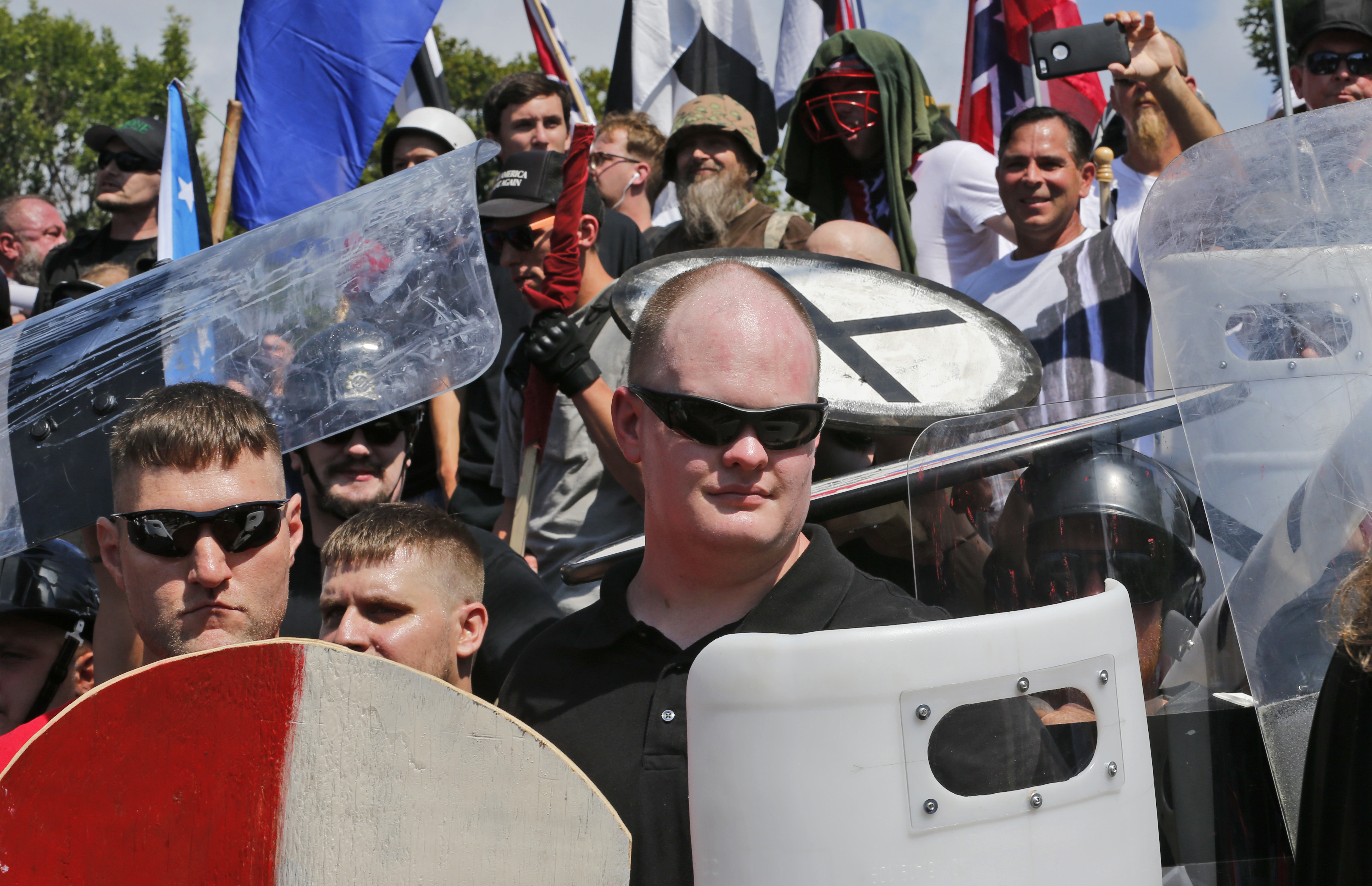 White nationalist demonstrators guard the entrance to Lee Park in Charlottesville, Va., Saturday, Aug. 12, 2017. CREDIT: AP Photo/Steve Helber