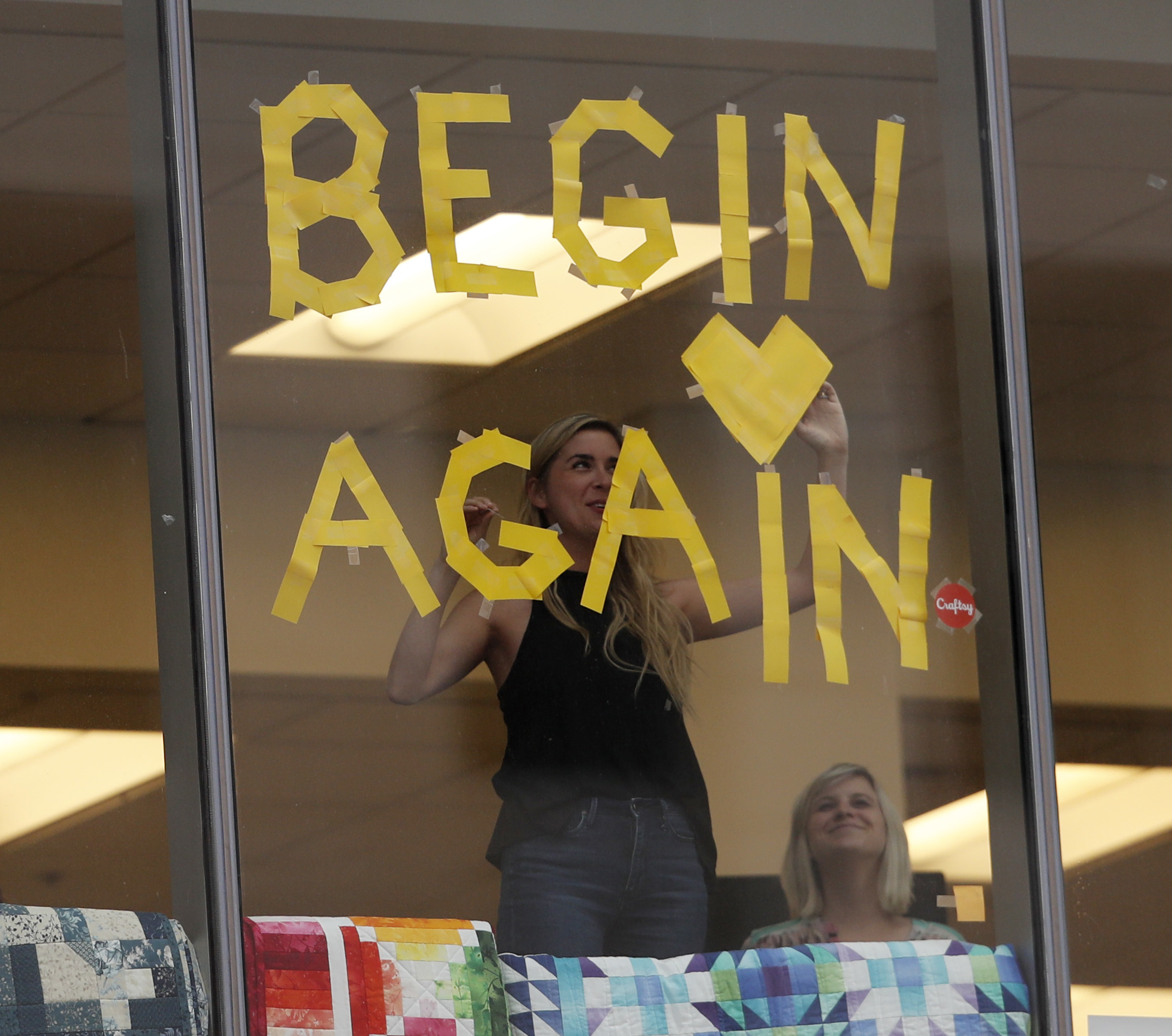 Office workers put up a new sign in support of pop singer Taylor Swift at the end of the civil trial involving the pop singer in a case in federal court Monday, Aug. 14, 2017, in Denver. CREDIT: AP Photo/David Zalubowski