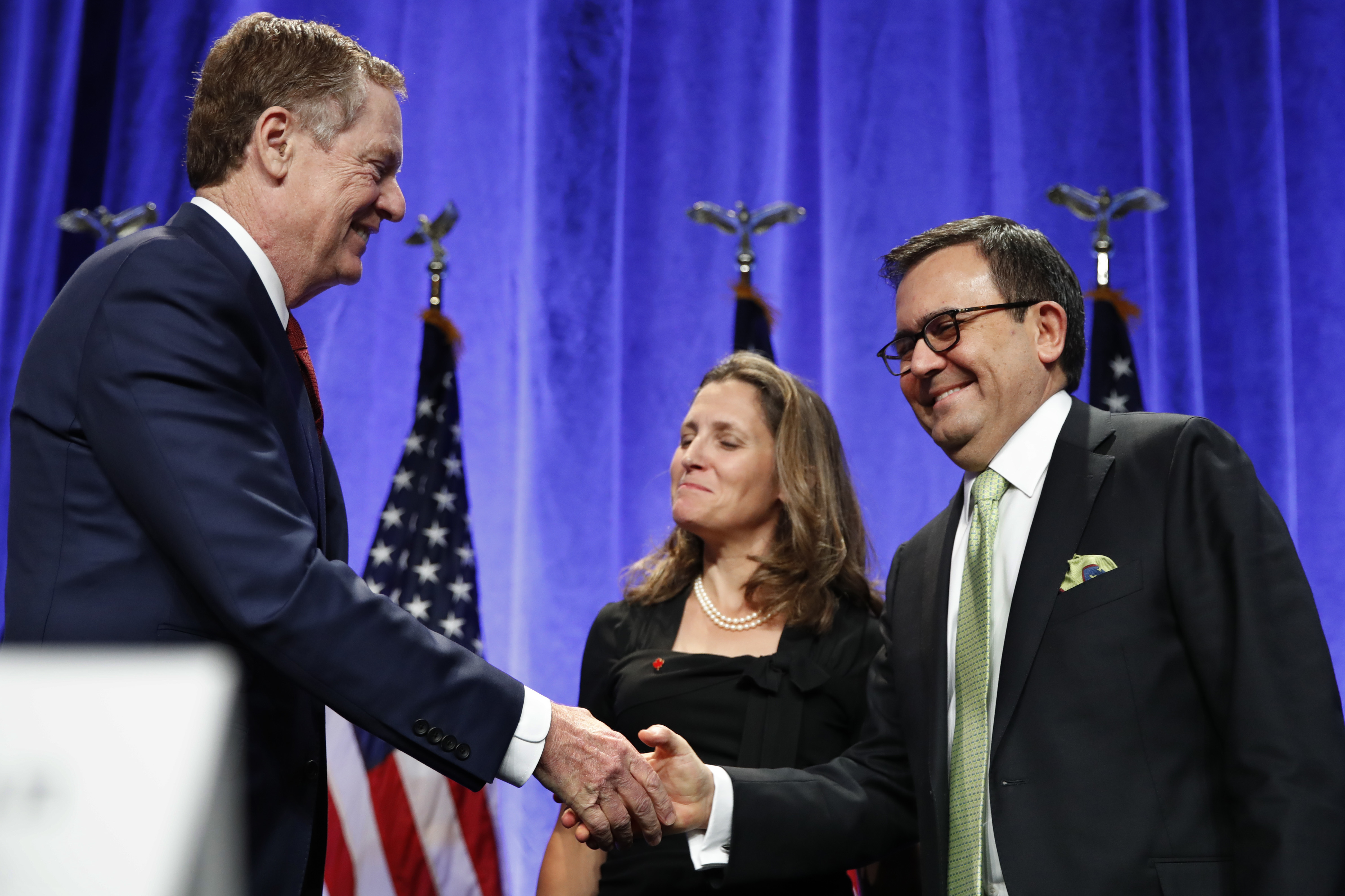 Who is in the negotiating room: U.S. Trade Representative Robert Lighthizer, left, shakes hands with Mexico's Secretary of Economy Ildefonso Guajardo Villarreal, accompanied by Canadian Foreign Affairs Minister Chrystia Freeland, at the start of NAFTA Renegotiations in Washington. CREDIT: AP Photo/Jacquelyn Martin