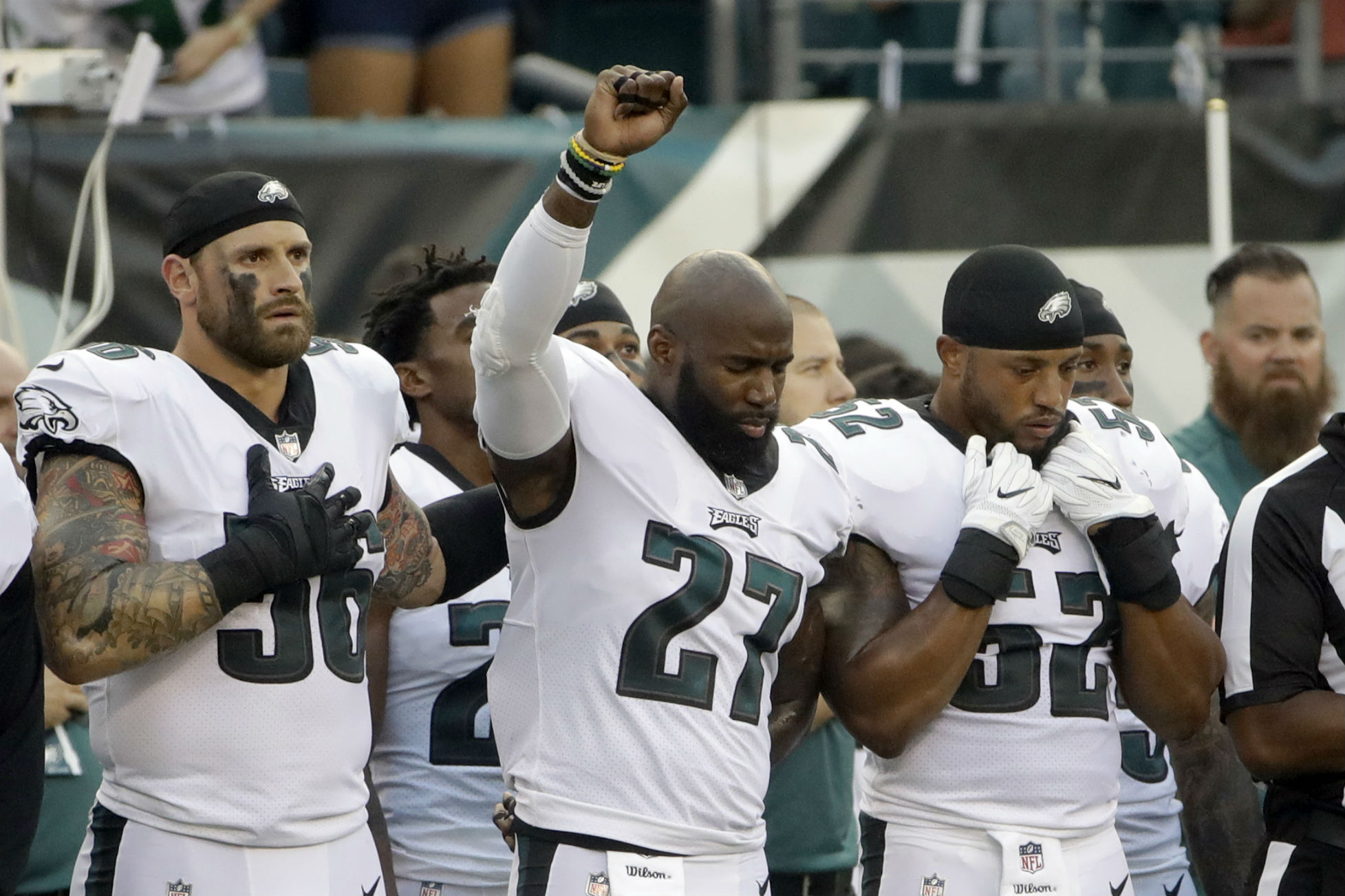 With Long's arm around his shoulder, Malcolm Jenkins raises his fist during the national anthem before an NFL preseason game in Philadelphia on Thursday. CREDIT: AP Photo/Matt Rourke