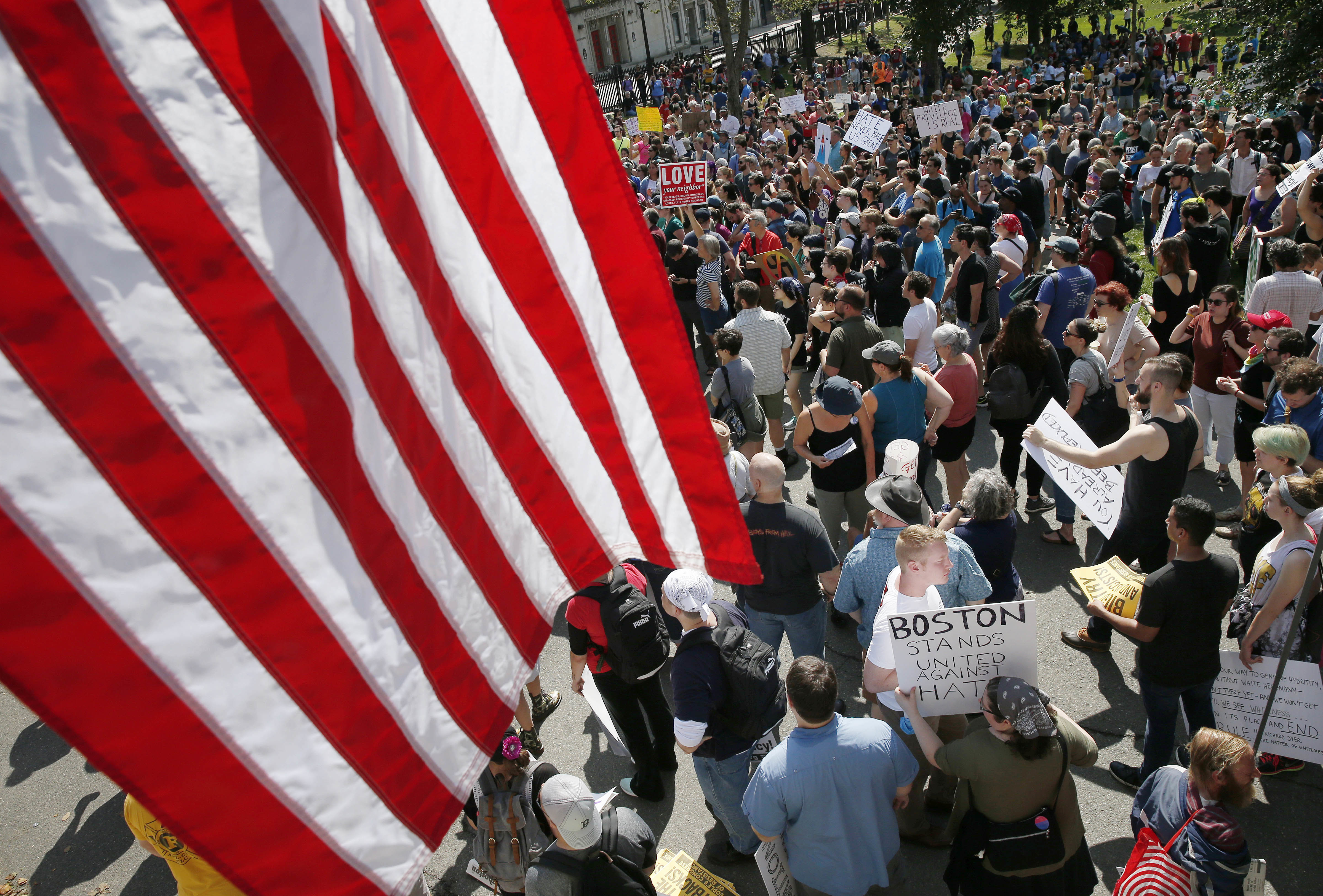 Counterprotesters assemble at the Statehouse before a planned "Free Speech" rally by conservative organizers begins on the adjacent Boston Common, Saturday, Aug. 19, 2017, in Boston. CREDIT: AP Photo/Michael Dwyer