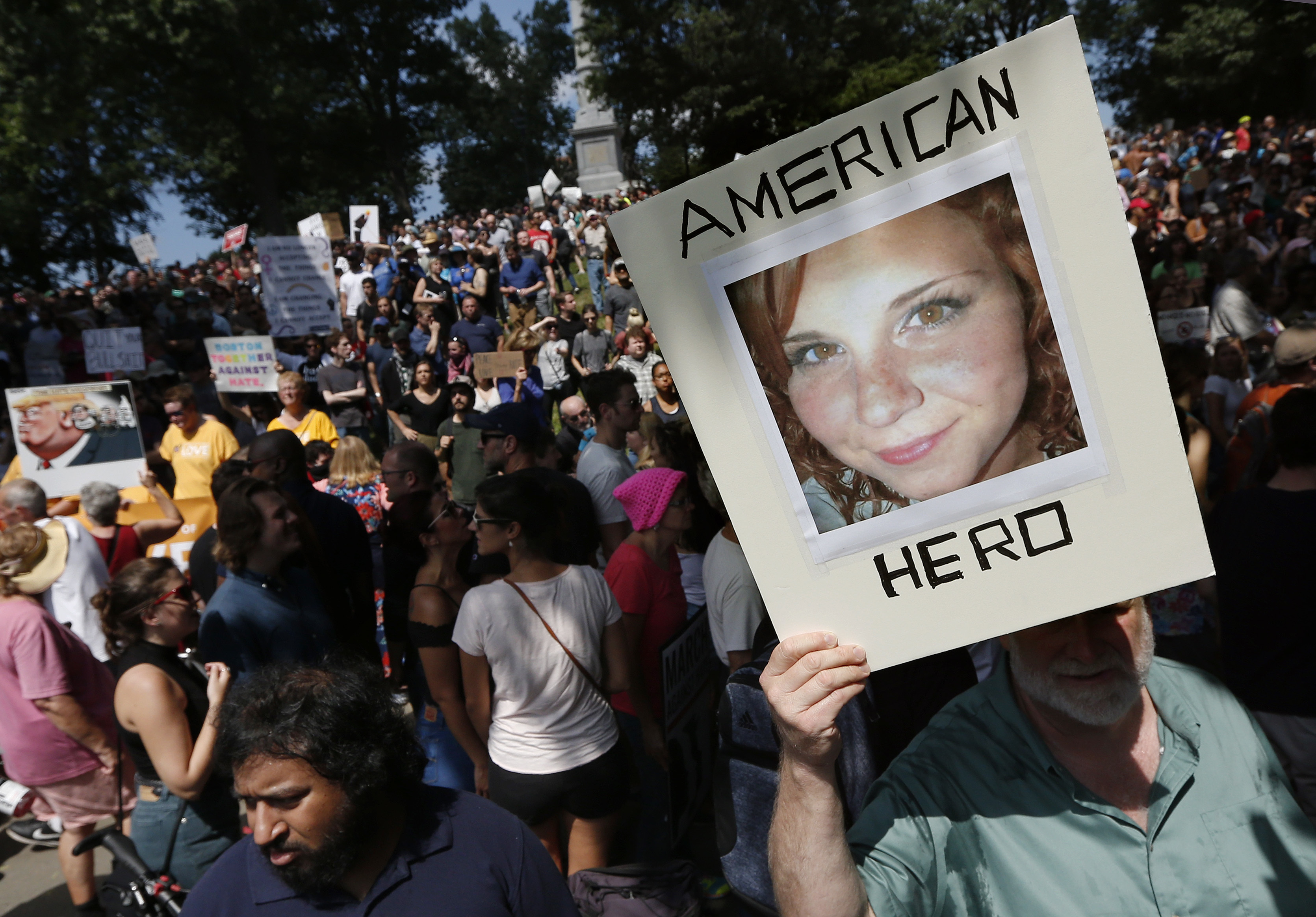 A counterprotester holds a photo of Heather Heyer on Boston Common at a "Free Speech" rally organized by conservative activists in Boston. Heyer was killed when a car, driven by James Alex Fields Jr., plowed into a group of people during protests in Charlottesville, Va. CREDIT: AP Photo/Michael Dwyer