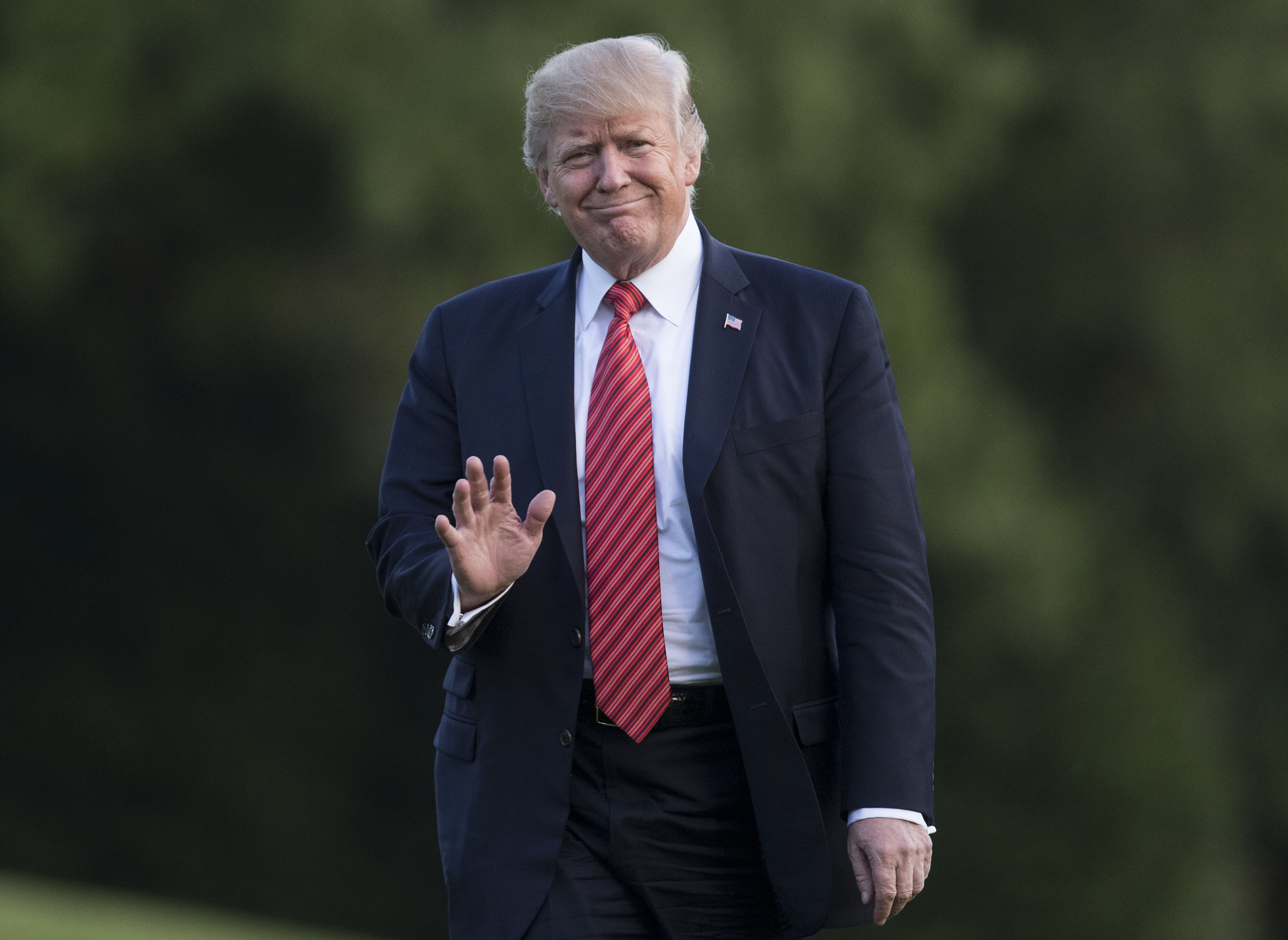 President Donald Trump waves as he walks from Marine One across the South Lawn of the White House in Washington, Wednesday, Aug. 23, 2017, as he returns from Reno, Nev. CREDIT: AP Photo/Carolyn Kaster