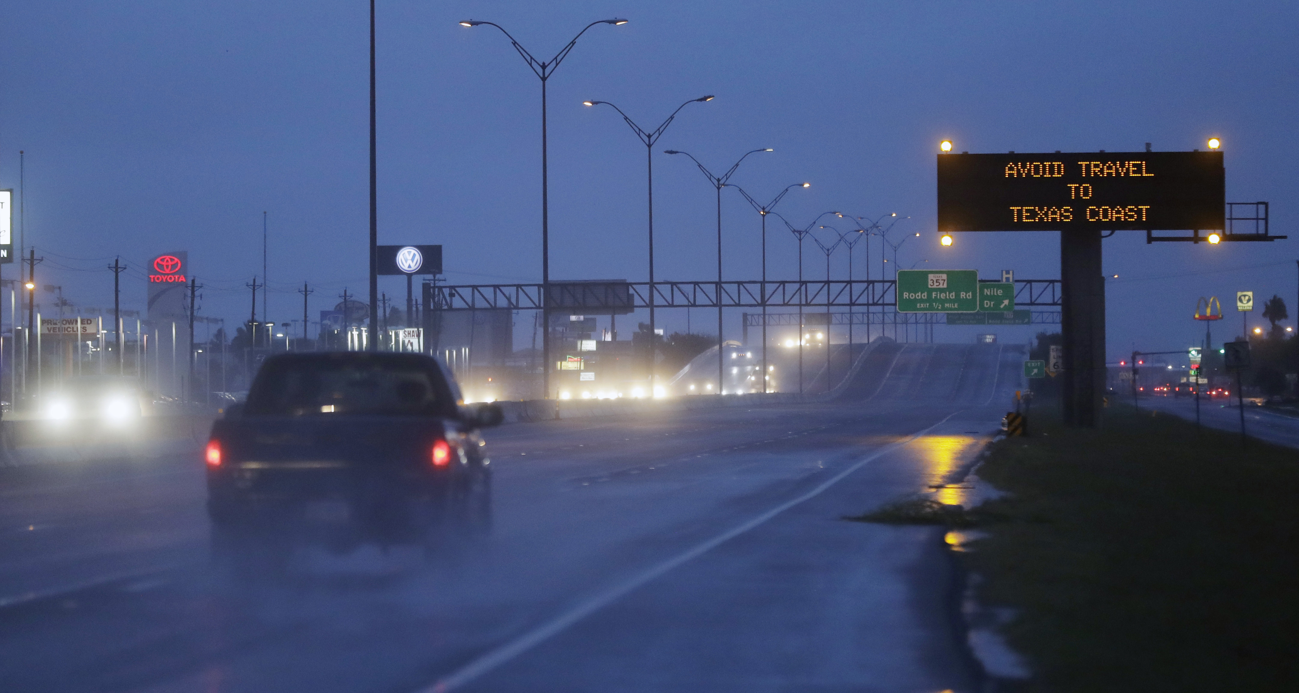 Motorists pass a warning sign as Hurricane Harvey approaches the Gulf Coast area Friday, Aug. 25, 2017, in Corpus Christi, Texas. The slow-moving hurricane could be the fiercest such storm to hit the United States in almost a dozen years. Forecasters labeled Harvey a "life-threatening storm" that posed a "grave risk" as millions of people braced for a prolonged battering. (AP Photo/Eric Gay)