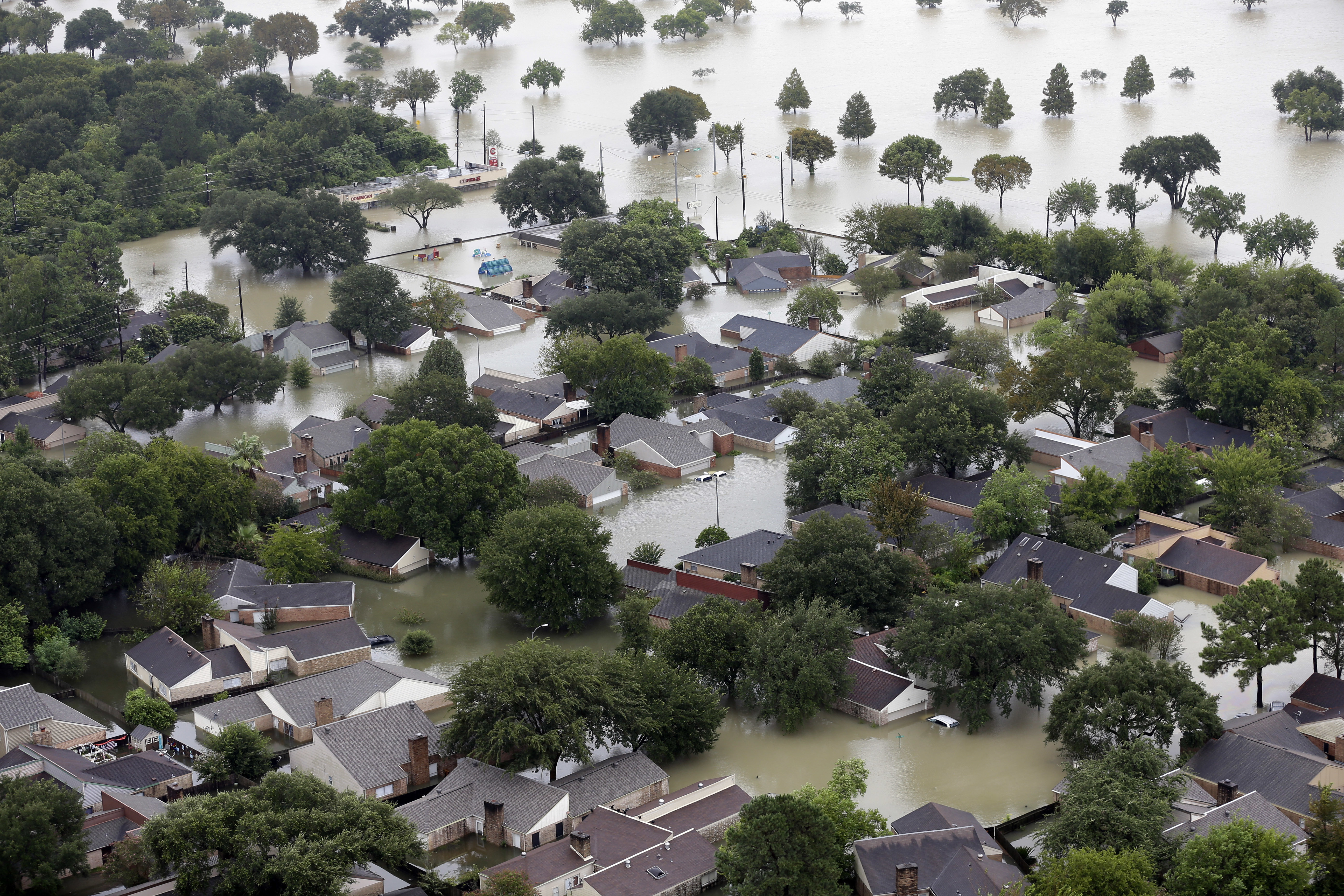 Homes are flooded near the Addicks Reservoir as floodwaters from Tropical Storm Harvey rise Tuesday, Aug. 29, 2017, in Houston. (CREDIT: AP Photo/David J. Phillip)