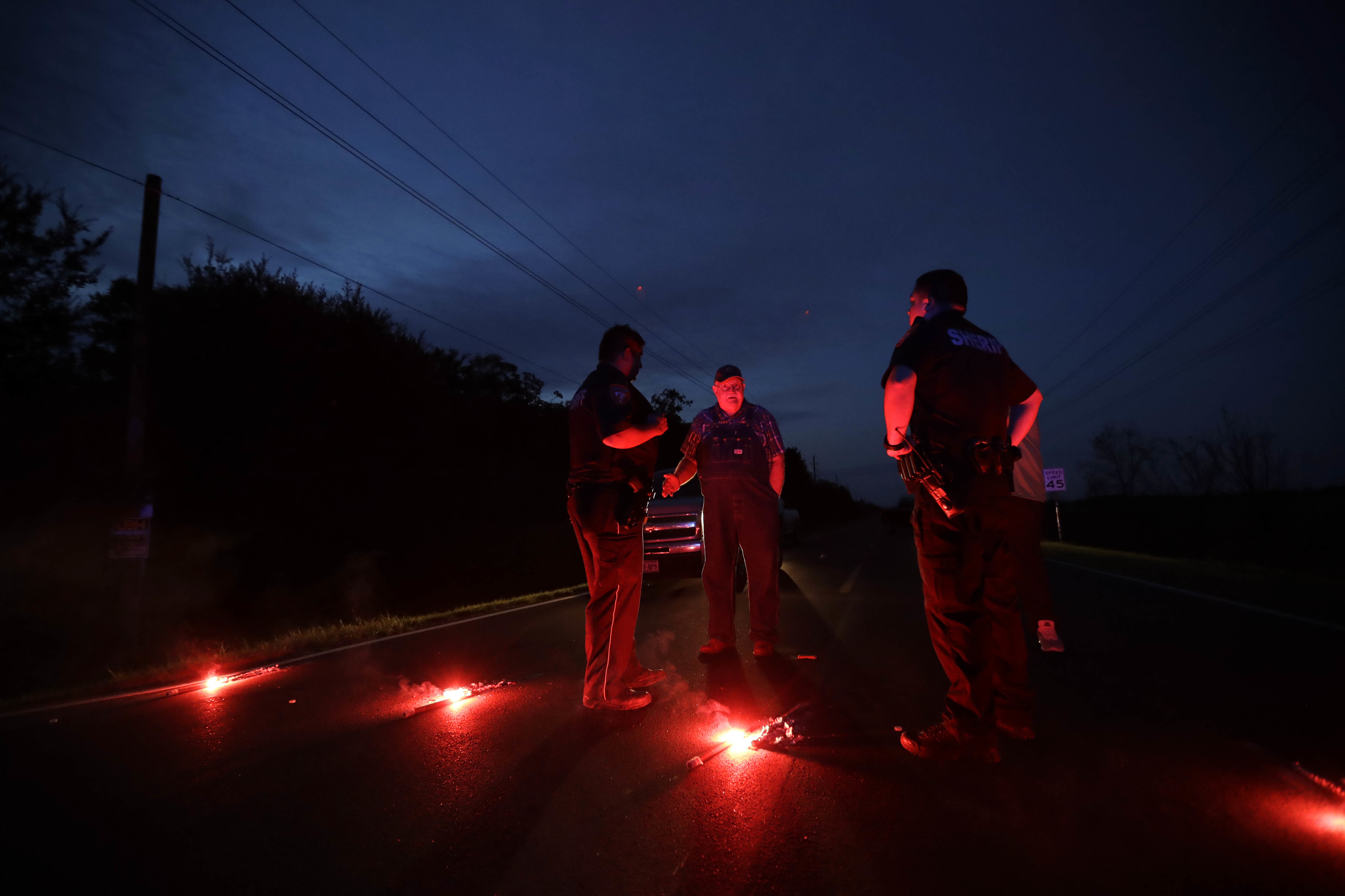 A man talks with officers at a roadblock less than three miles from the Arkema Inc. chemical plant Thursday, Aug. 31, 2017, in Crosby, Texas. (CREDIT: AP Photo/Gregory Bull)