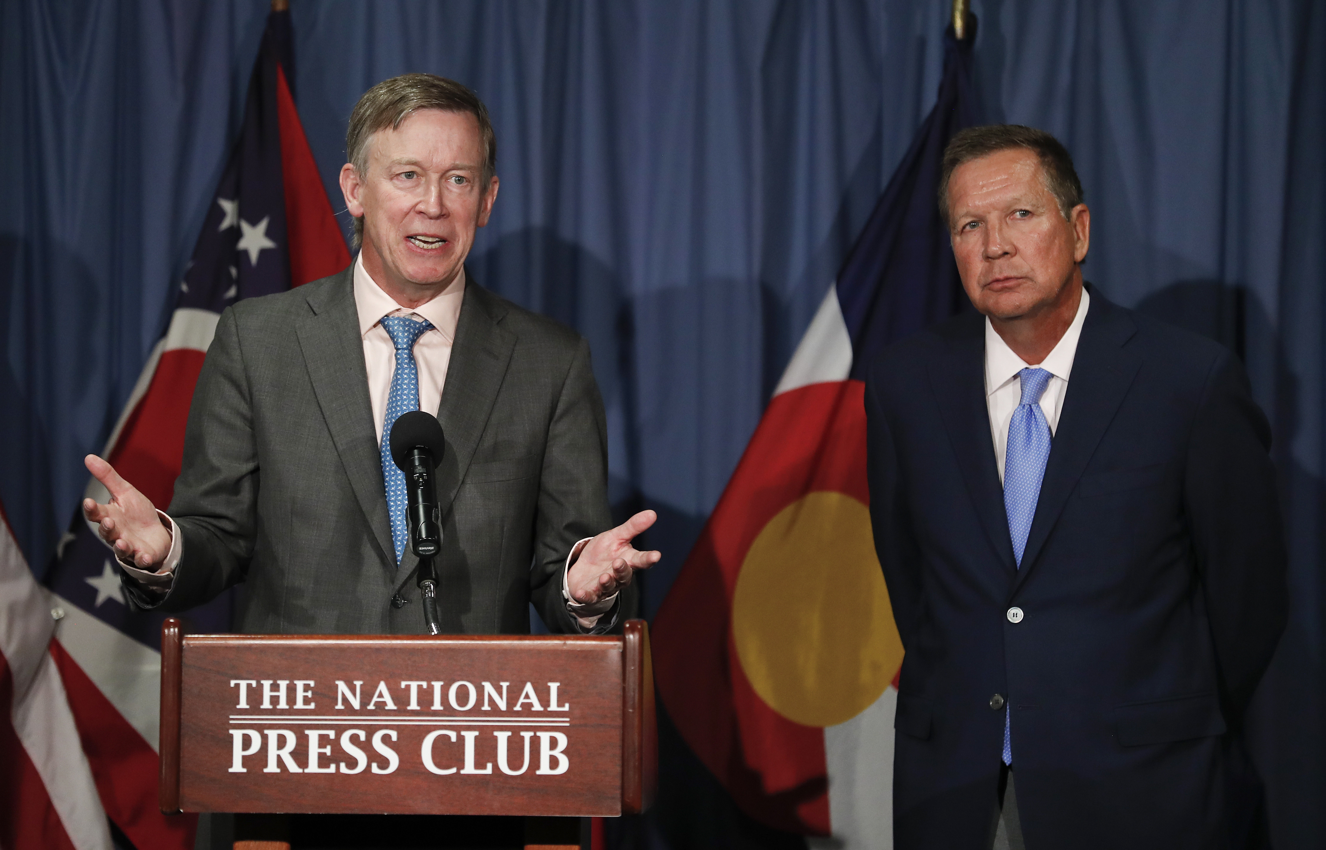 In this June 27, 2017, file photo, Colorado Gov. John Hickenlooper, left, joined by Ohio Gov. John Kasich, speaks during a news conference at the National Press Club in Washington. CREDIT: AP Photo/Carolyn Kaster, file