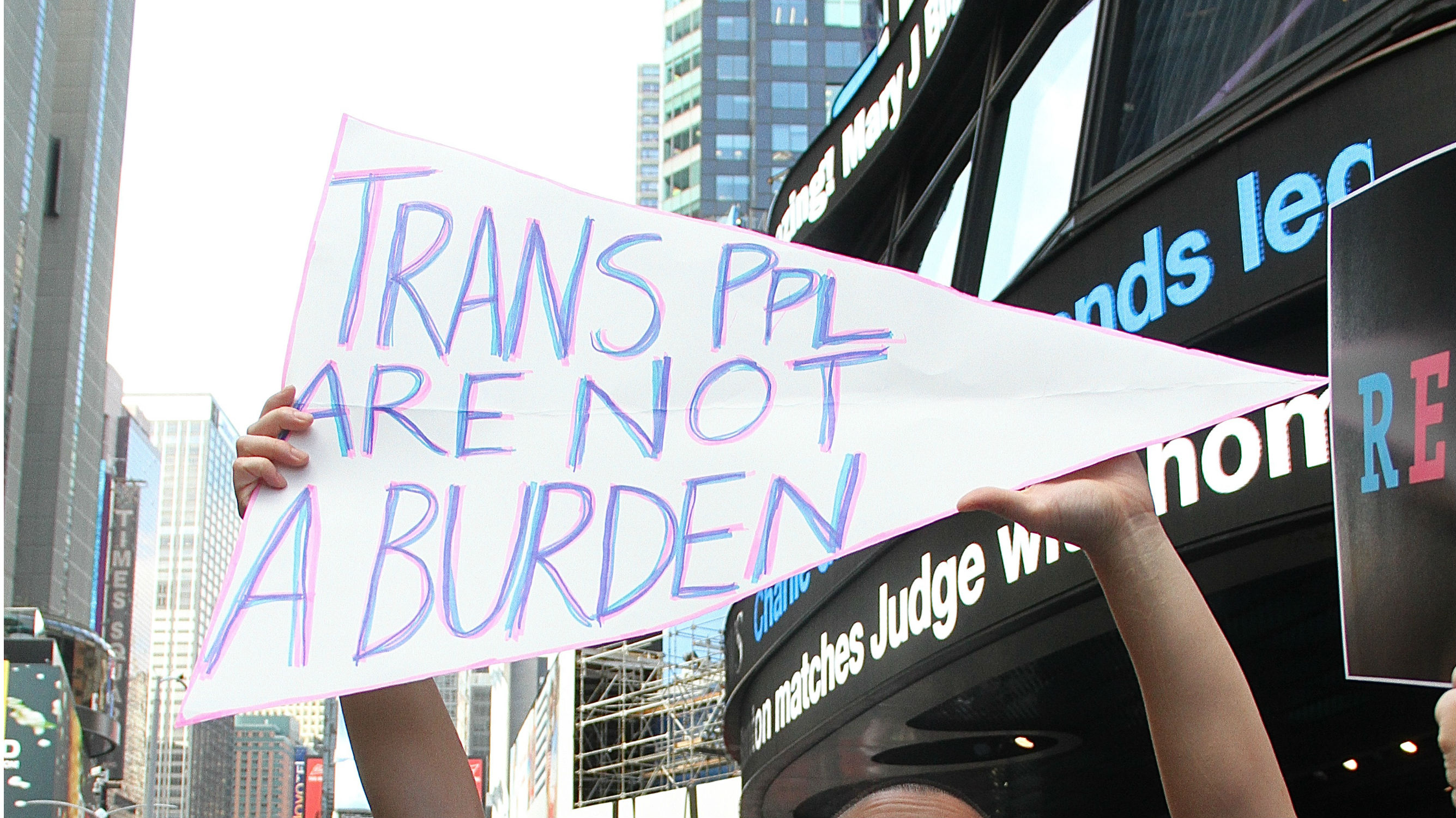A sign from a Times Square protest of President Trump's ban on transgender military service. CREDIT: Rainmaker Photo/MediaPunch/IPX