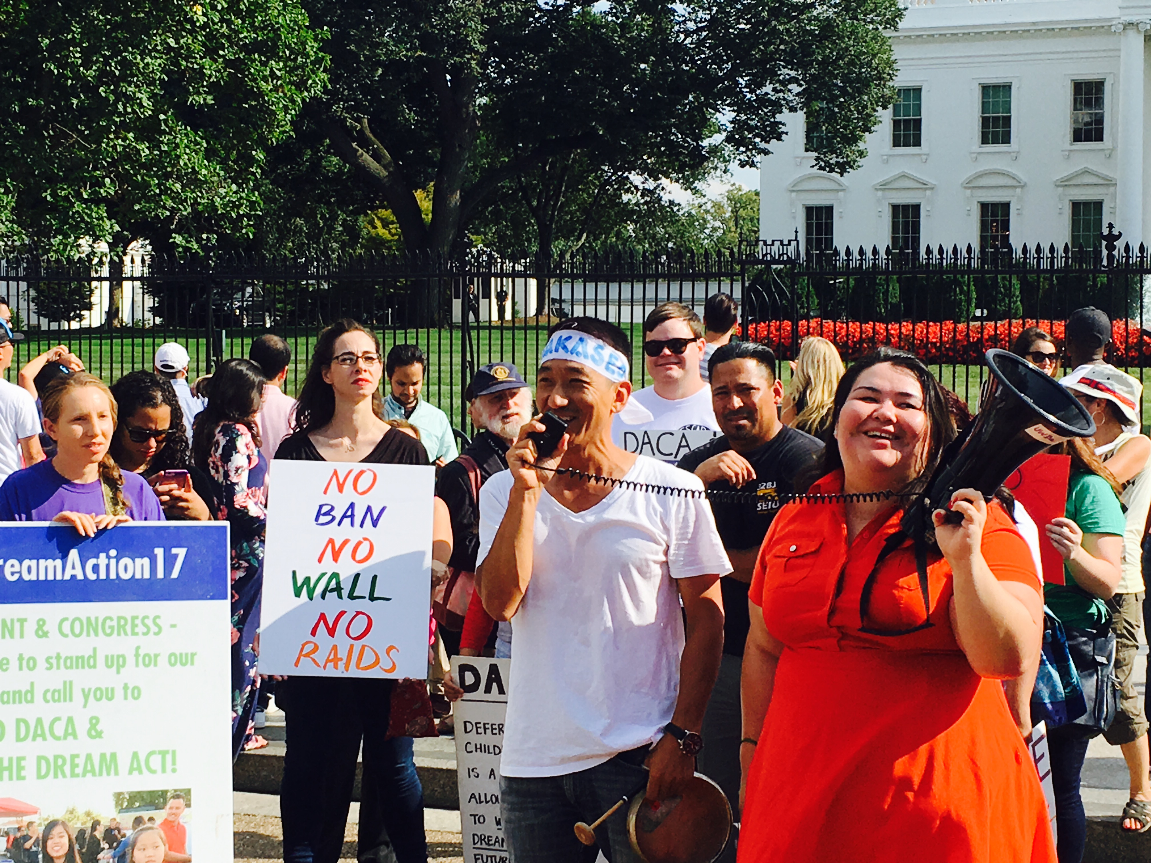 Dae Joong "DJ" Yoon, Co-Director at NAKASEC (center left) and Greisa Martinez, Advocacy Director at United We Dream Network (center right) during a immigrant rally on August 25, 2017. CREDIT: Esther Lee/ThinkProgress
