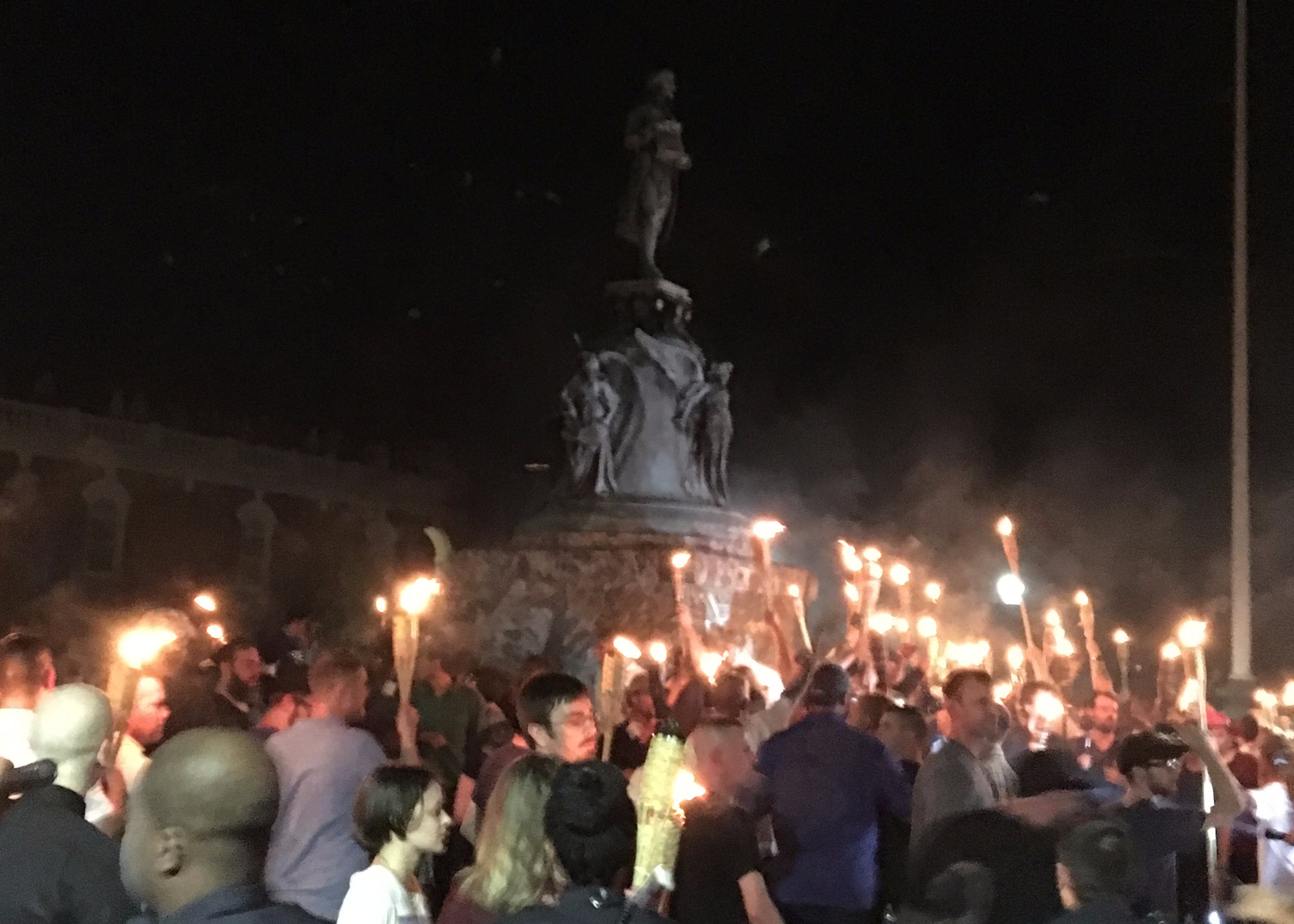 White nationalist protesters surround the Thomas Jefferson statue and a small group of counter-protesters at the University of Virginia on Friday night. (Joshua Eaton/ThinkProgress)
