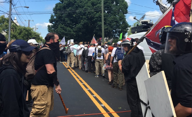 Fights occasionally break into the open with clubs, shields, pepper spray. The only de-escalation is self-policing by each side. CREDIT: ThinkProgress/Joshua Eaton