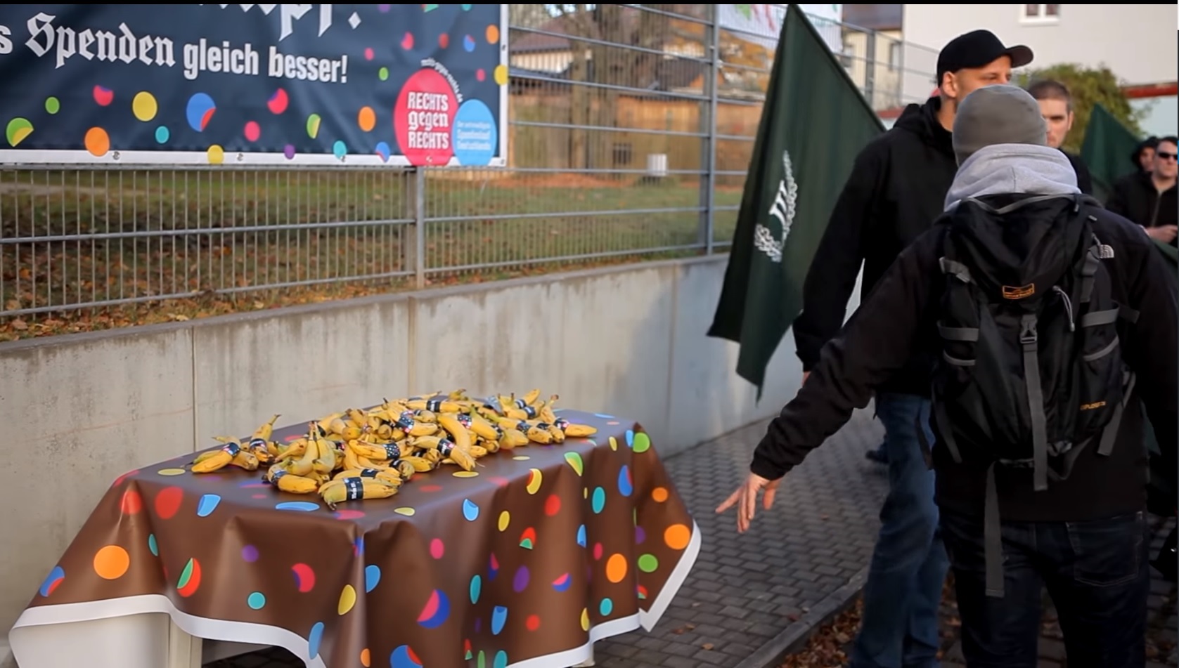 German neo-Nazis stand before a table full of bananas laid out for them as part of an elaborate prank. (CREDIT: Screenshot from Rechts gegen Rechts video)