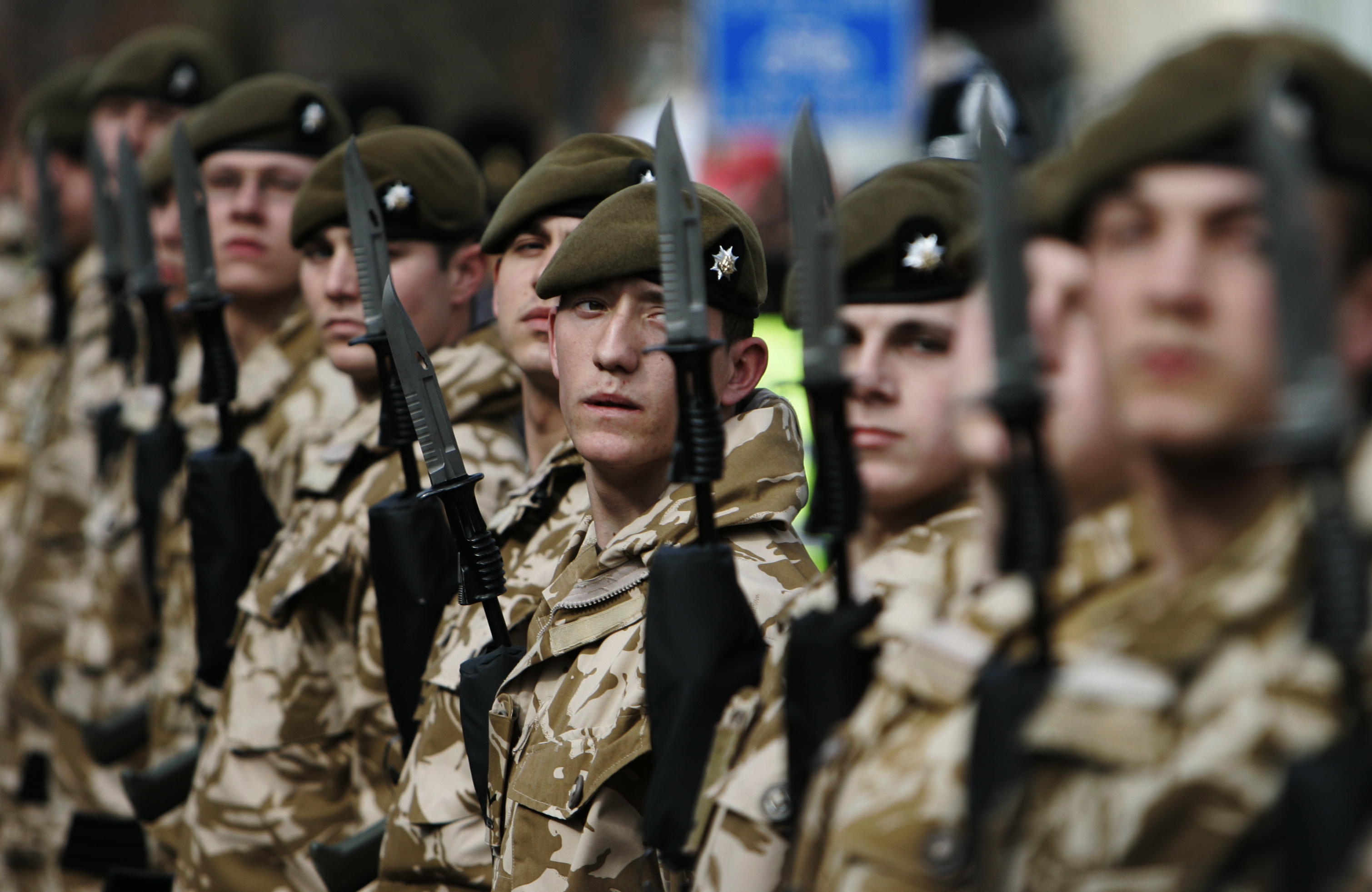 British soldiers from the 2nd Battalion, The Royal Anglian Regiment, wait for inspection following their parade through the town of Watford, England, Wednesday March 11, 2009. The regiment recently back from a tour of duty in Afghanistan (AP stock photo/Lefteris Pitarakis)