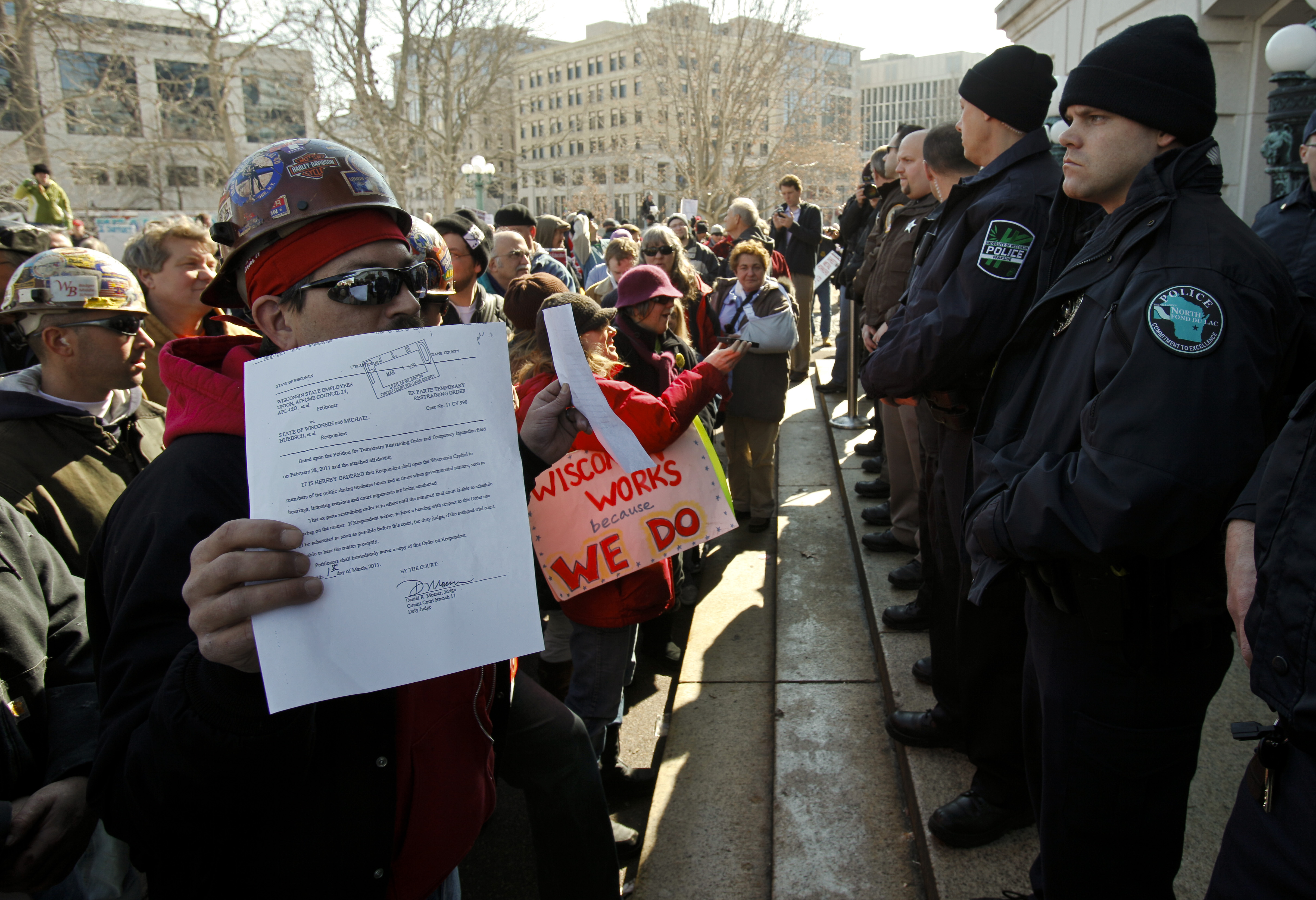 Union Iron Worker Randy Bryce of Milwaukee holds up a court order to open the doors of the state Capitol in front of police officers in Madison, Wis., Tuesday, March 1, 2011. Opponents to the governor's bill to eliminate collective bargaining rights for many state workers are in the 14th day of protests . CREDIT: AP Photo/Andy Manis