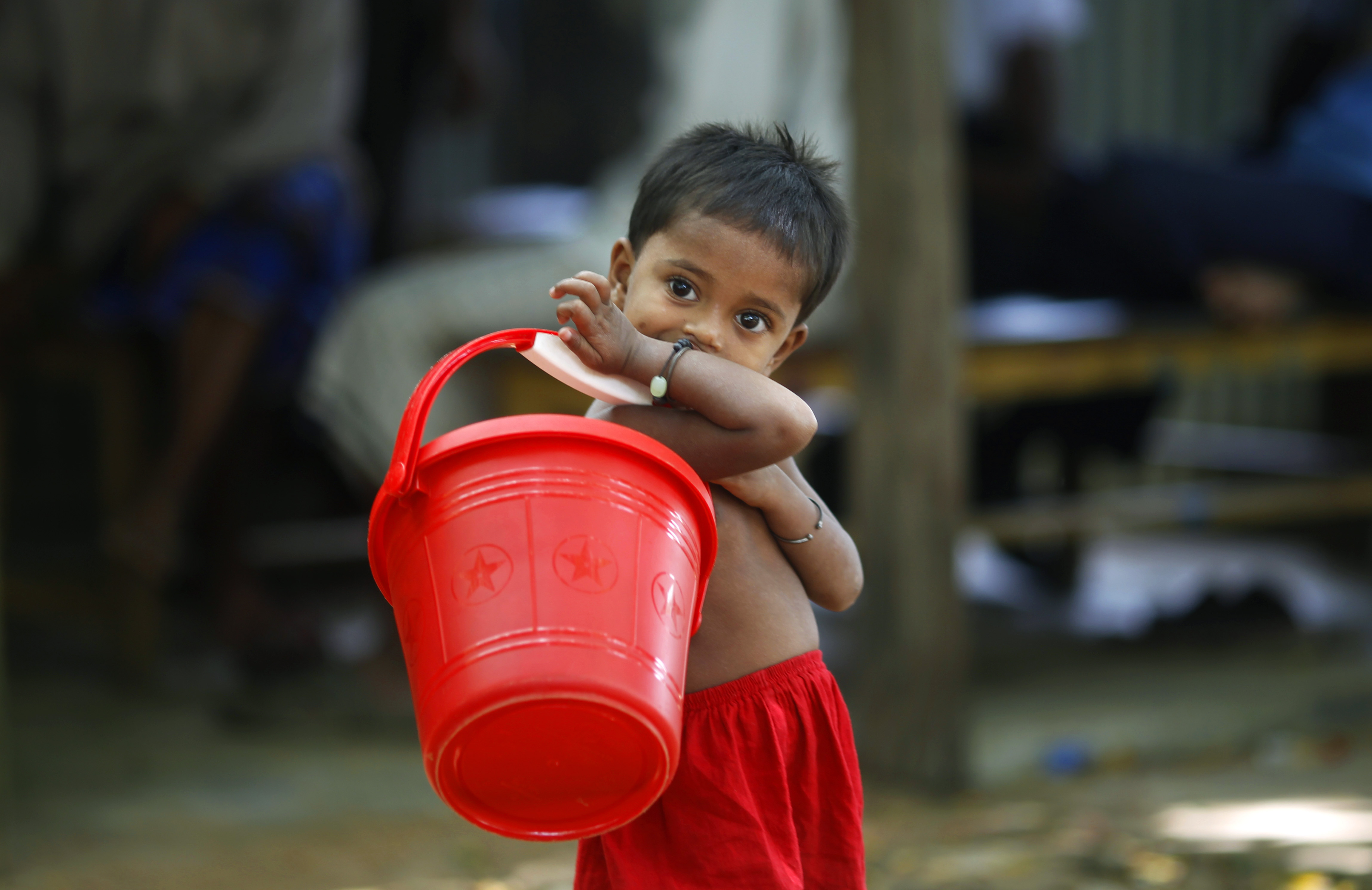 A young Rohingya Muslim girl stands near the entrance to a registered camp run by the UNHCR for Rohingya Muslim refugees who fled Myanmar during an ethnic strife in 1992, in Kutupalong, Bangladesh on World Refugee Day, Wednesday, June 20, 2012. World Refugee Day, a day initiated by the United Nations to raise awareness on the plight of refugees worldwide, is observed on June 20 every year. CREDIT: AP Photo/Saurabh Das