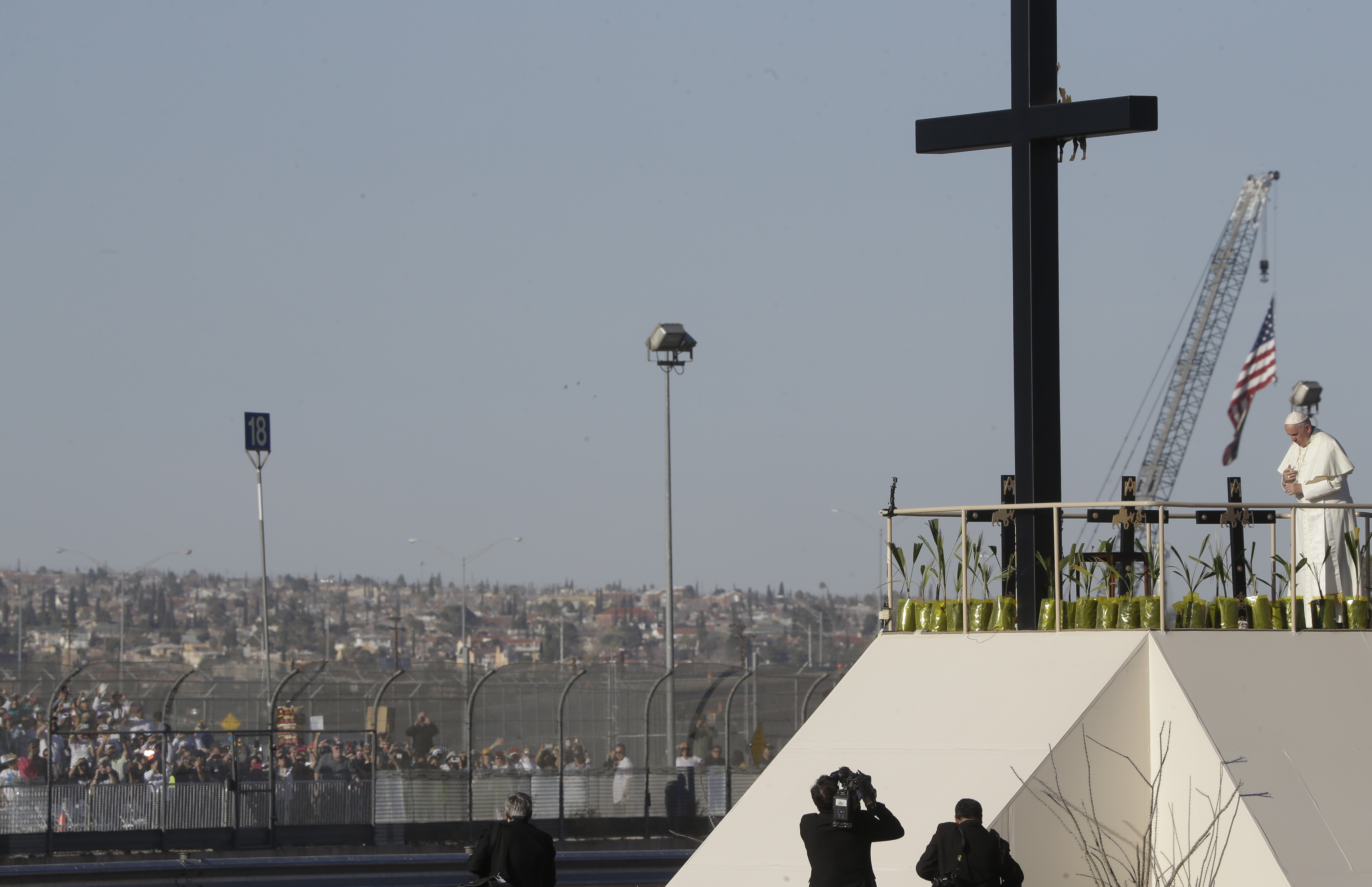 Hundreds of people gathered a few yards away on the U.S. side watch as Pope Francis prays near the U.S.-Mexico border fence along the Rio Grande, in Ciudad Juarez, Mexico, Wednesday, Feb. 17, 2016.
CREDIT: AP Photo/Gregorio Borgia