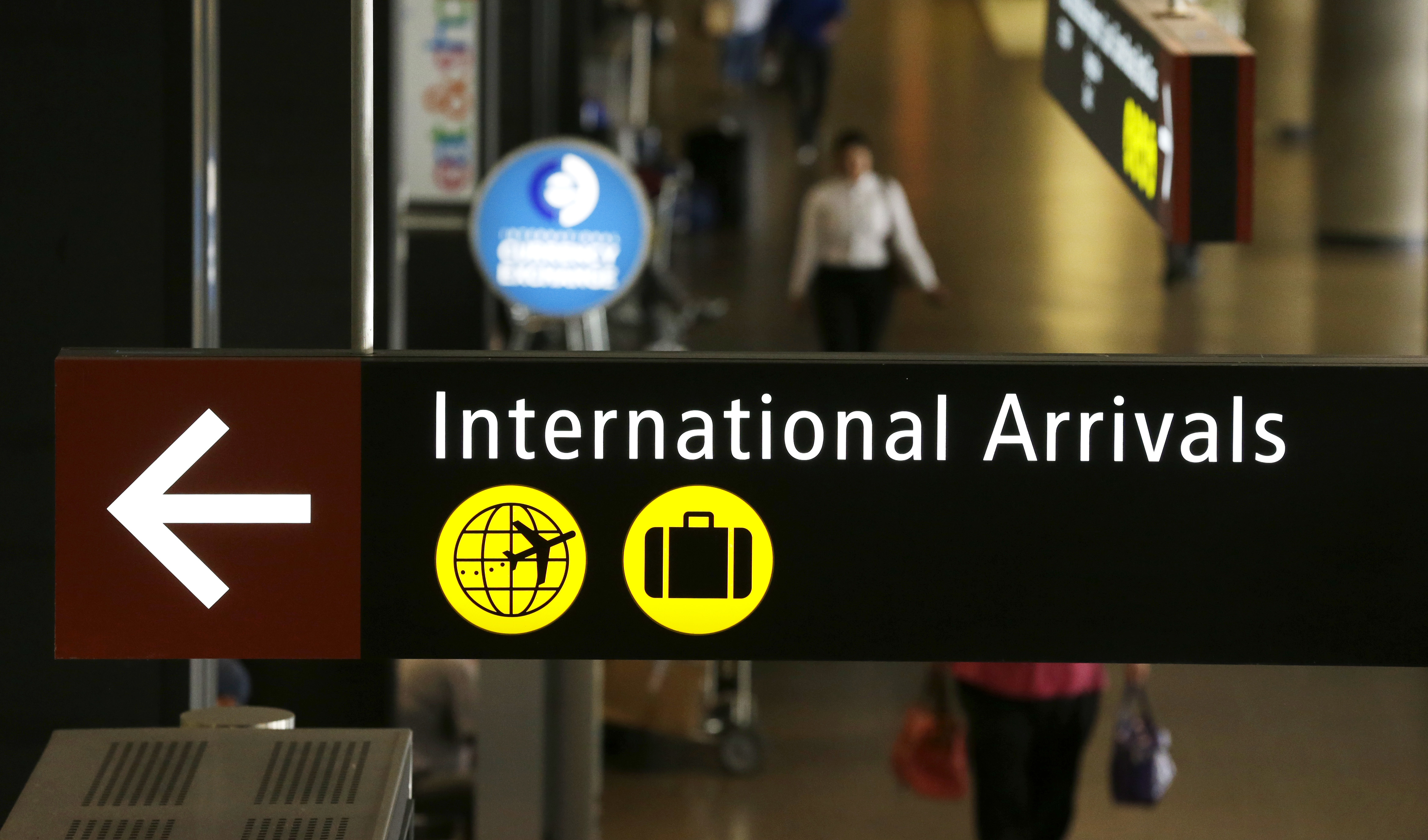 A sign for International Arrivals is shown at the Seattle-Tacoma International Airport, Monday, June 26, 2017, in Seattle. CREDIT: AP Photo/Ted S. Warren