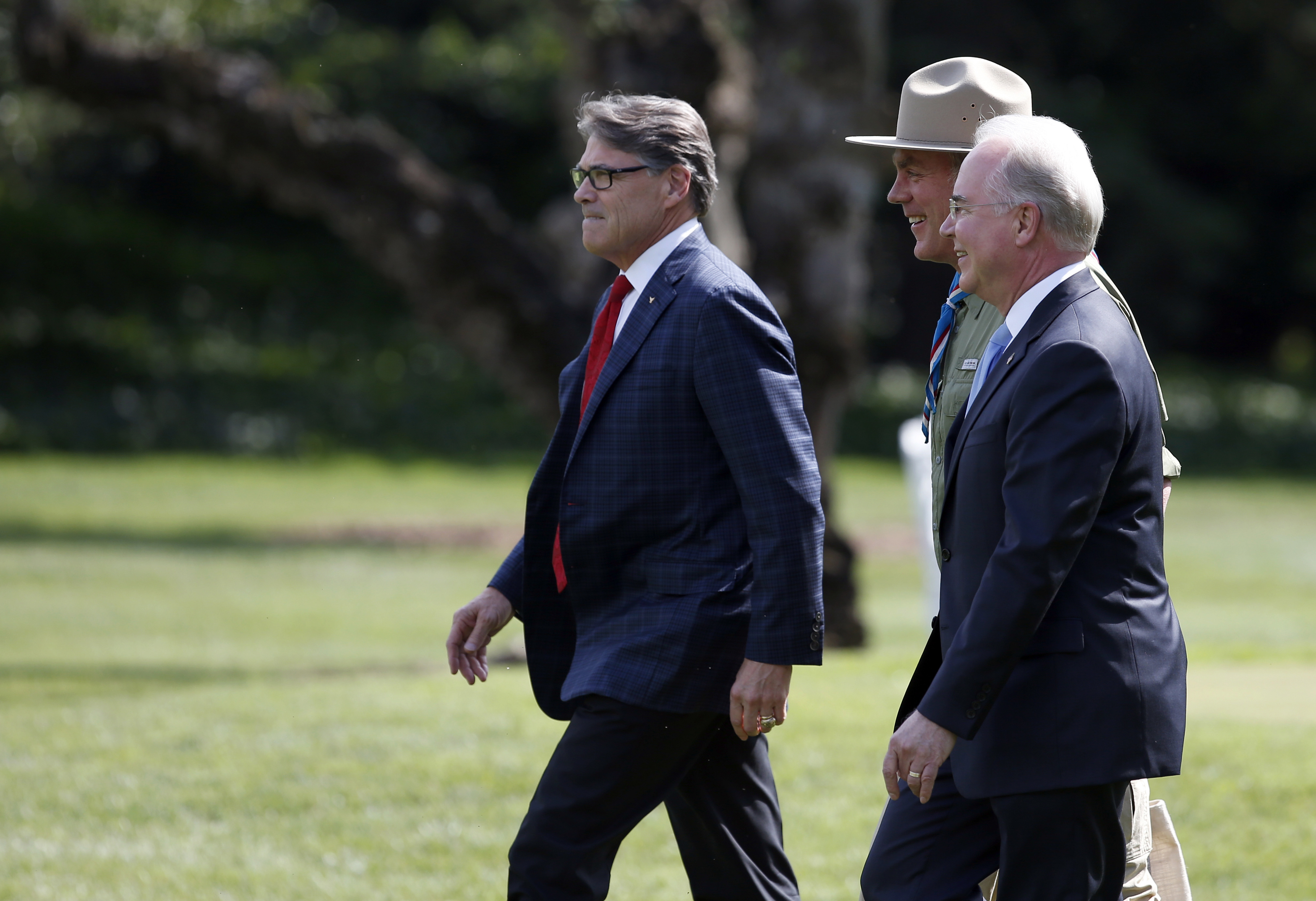 From left, Energy Secretary Rick Perry, Health and Human Services Secretary Tom Price and Interior Secretary Ryan Zinke walk across the South Lawn of the White House in Washington, Monday, July 24, 2017. CREDIT: AP Photo/Alex Brandon