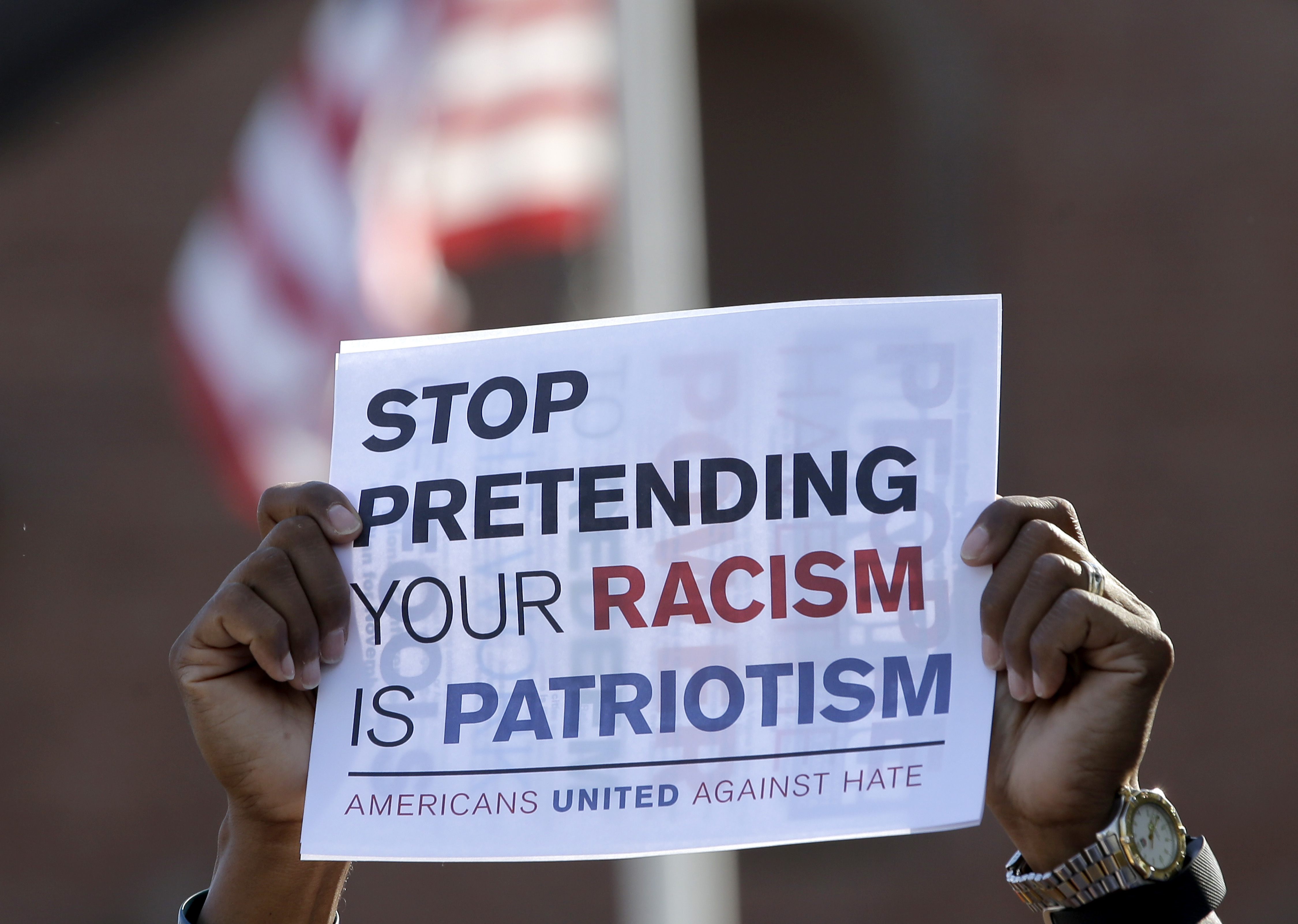 David Brown of Plymouth, MA holds a sign during a protest following the violence in Charlottesville, VA. CREDIT: AP Photo/Steven Senne