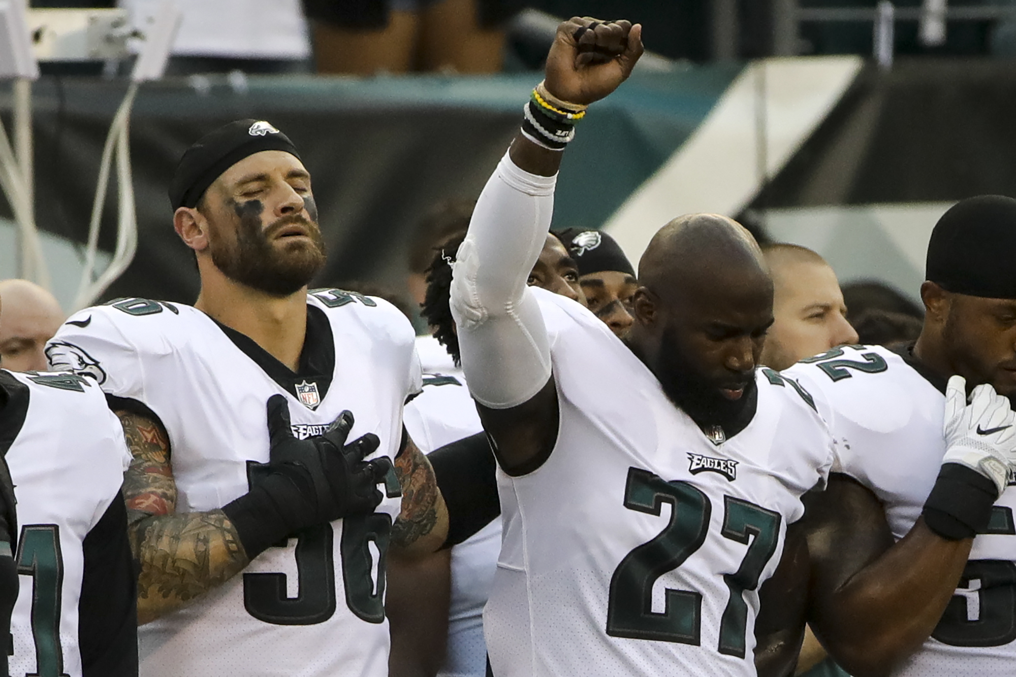 Philadelphia Eagles' Chris Long (56) stands beside Malcolm Jenkins (27) as he raises his fist during the national anthem before the team's NFL preseason football game against the Buffalo Bills, Thursday, Aug. 17, 2017, in Philadelphia. (AP Photo/Matt Rourke)
