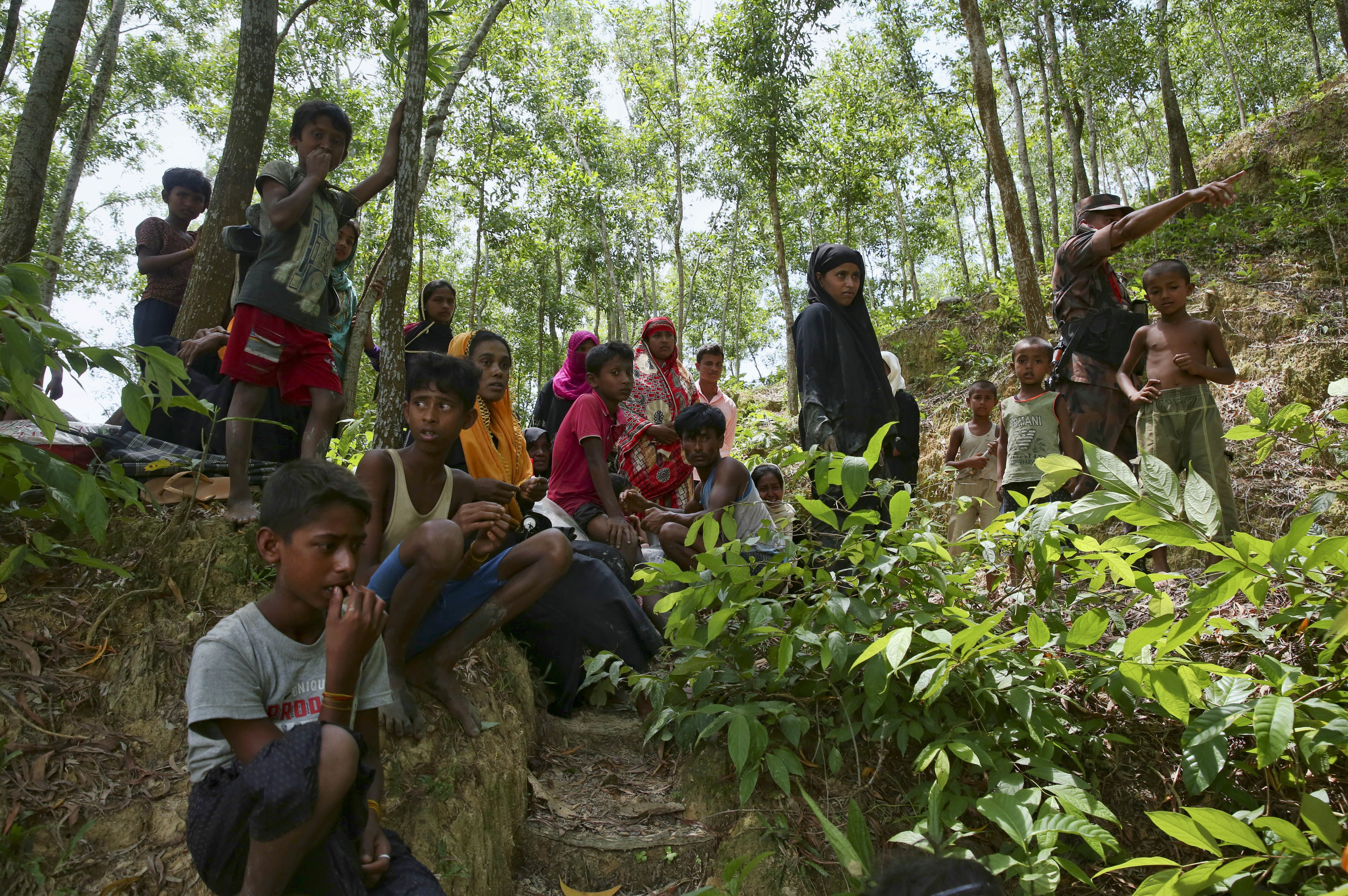 Fleeing Rohingya take shelter in a forested area on the Bangladeshi side of the border in, Ghumdhum. Several hundred Rohingya who were trying to escape Myanmar are stuck in a "no man's land" at the Myanmar - Bangladesh border. CREDIT: AP Photo/Mushfiqul Alam