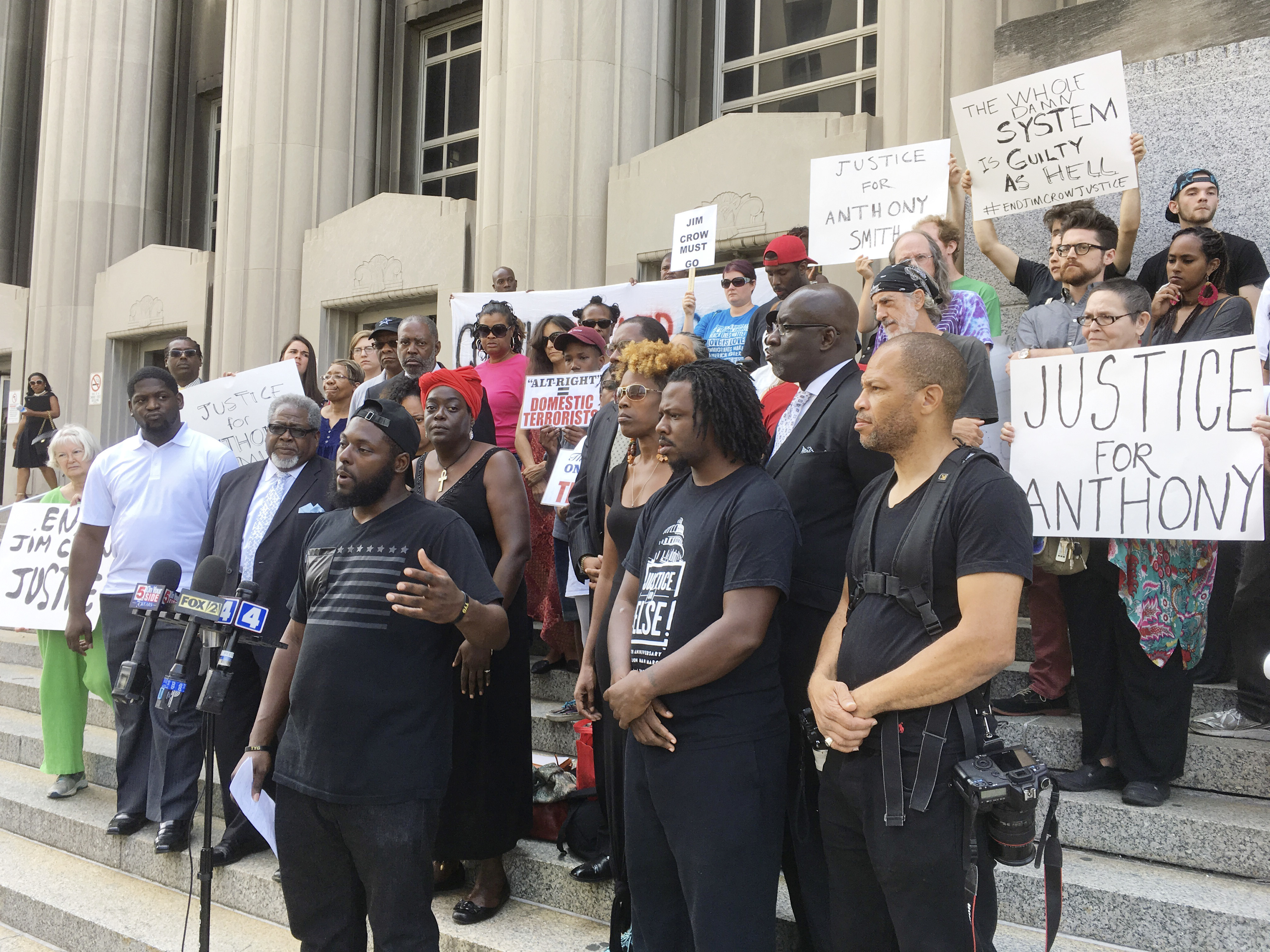 In this Aug. 28, 2017, photo, activists gather outside the St. Louis courthouse where former police officer Jason Stockley's murder trial was heard. (AP Photo/Jim Salter)